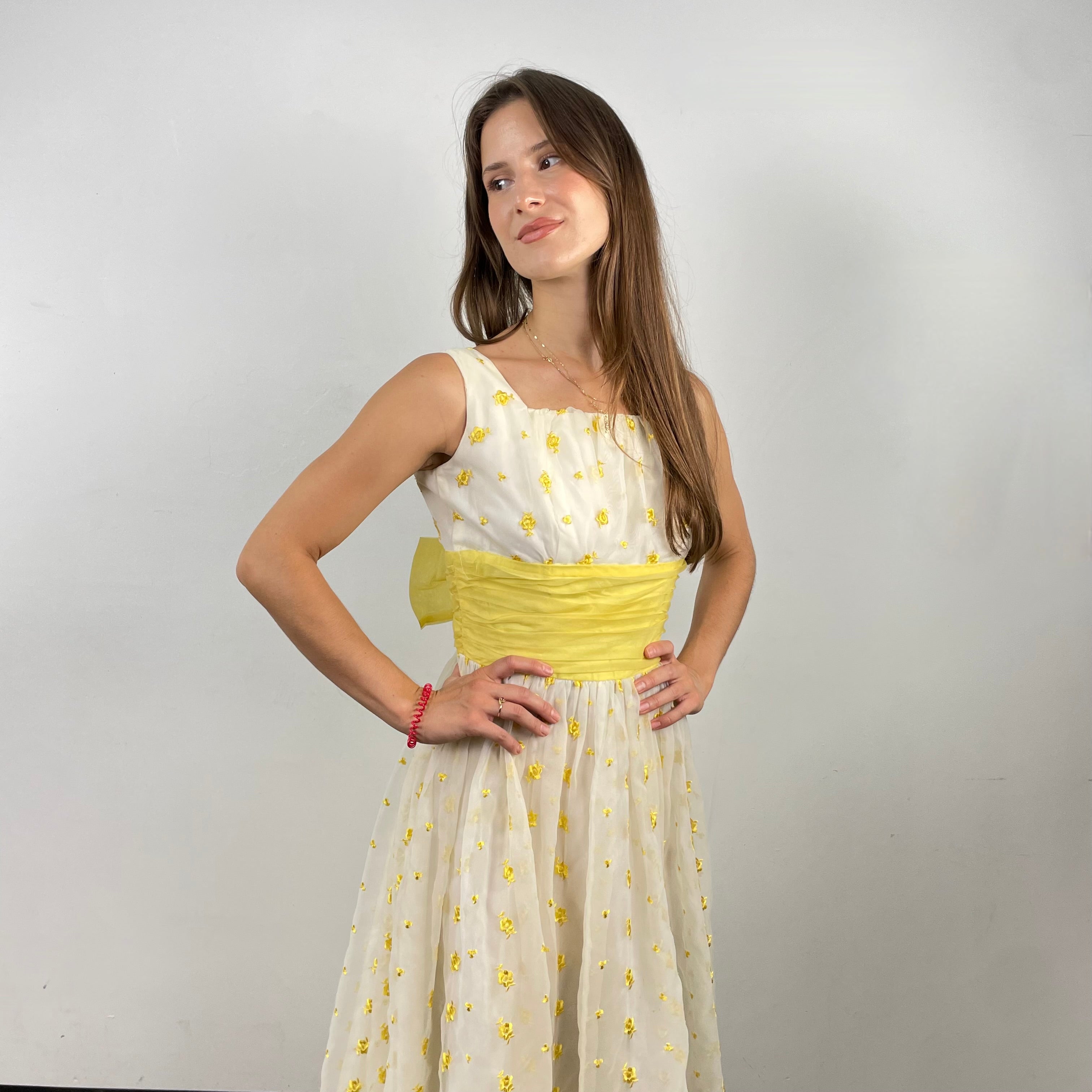 Boheme Vintage 1960s deadstock chiffon gown with yellow floral embroidery, square neckline, and oversized back bow.