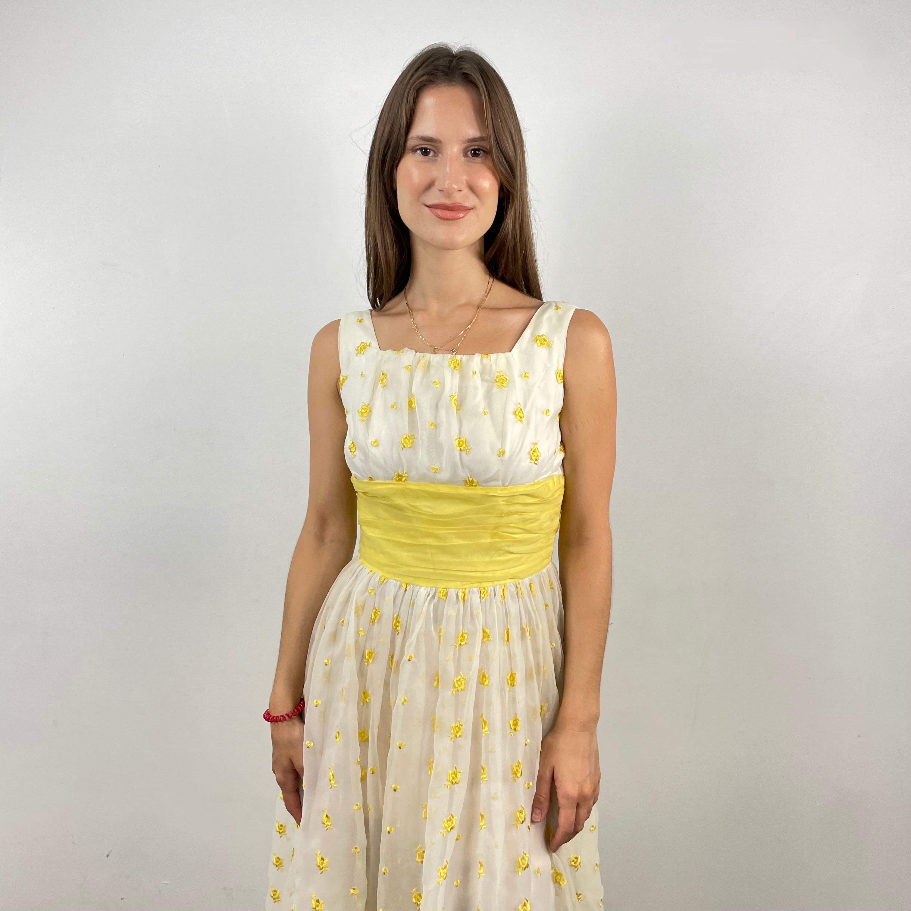 Boheme Vintage 1960s deadstock chiffon gown with yellow floral embroidery, square neckline, and oversized back bow.