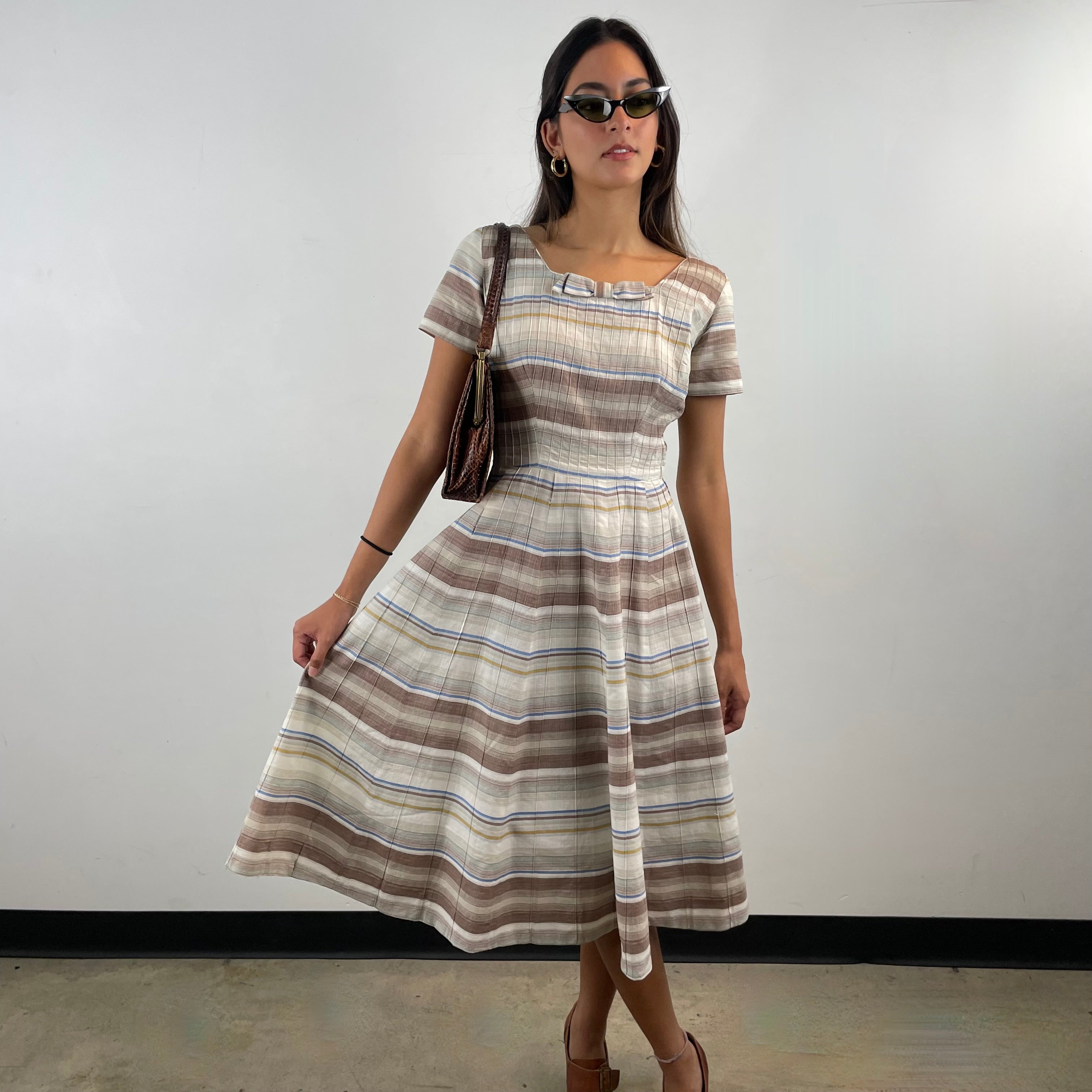 Vintage 1970s brown and cream striped maxi dress with green and blue bands, textured cotton fabric, fitted bodice, short sleeves and flared skirt.