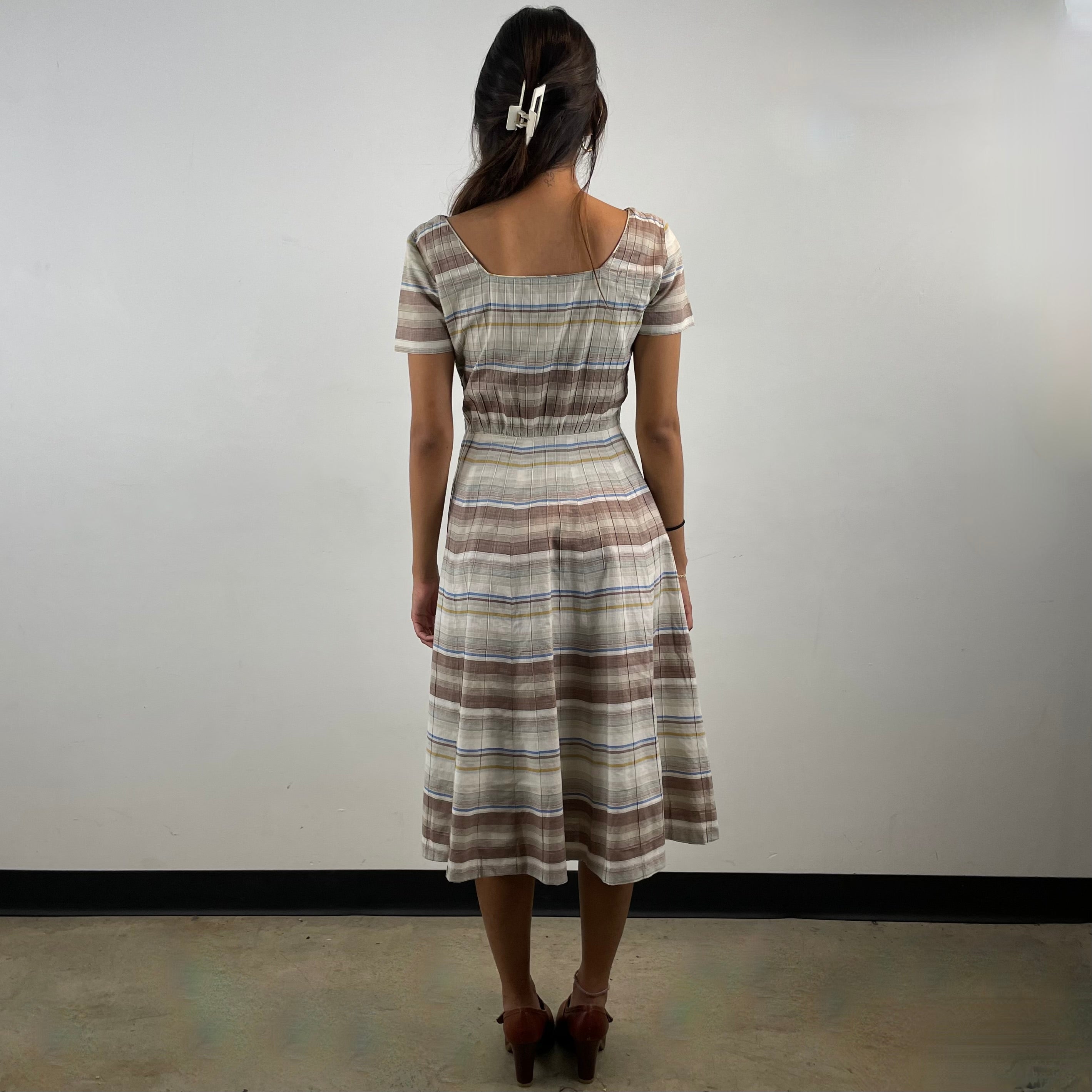 Vintage 1970s brown and cream striped maxi dress with green and blue bands, textured cotton fabric, fitted bodice, short sleeves and flared skirt.