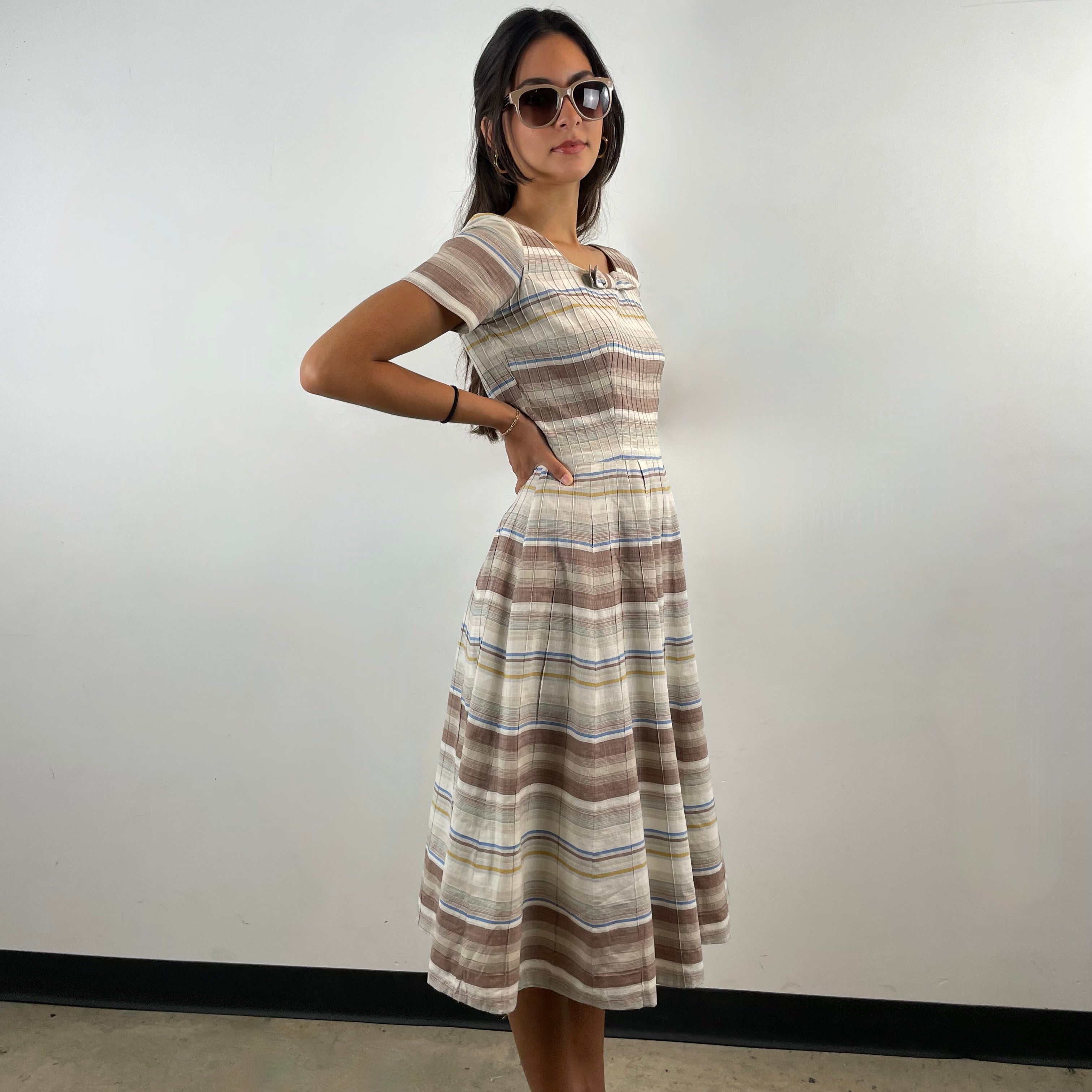Vintage 1970s brown and cream striped maxi dress with green and blue bands, textured cotton fabric, fitted bodice, short sleeves and flared skirt.