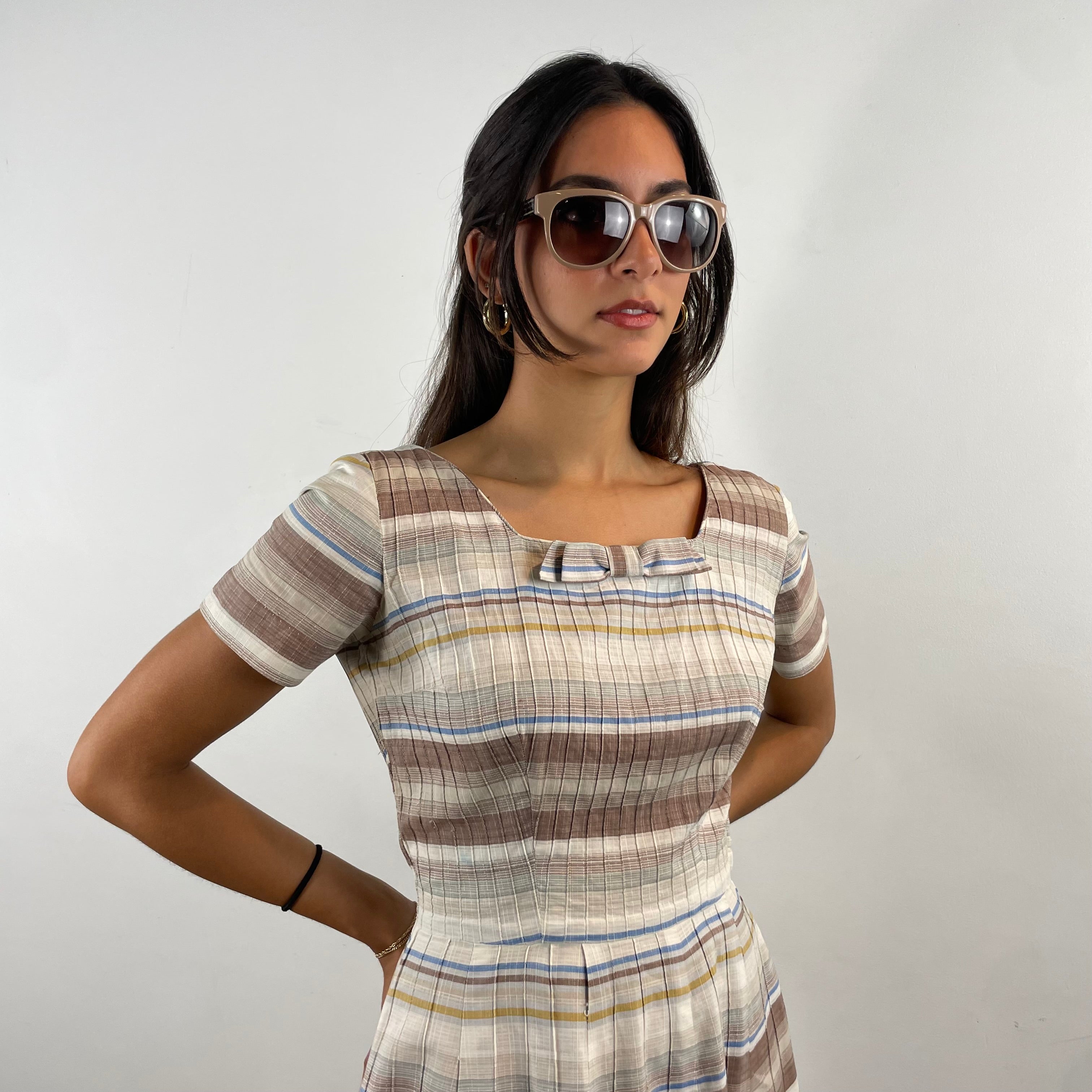 Vintage 1970s brown and cream striped maxi dress with green and blue bands, textured cotton fabric, fitted bodice, short sleeves and flared skirt.