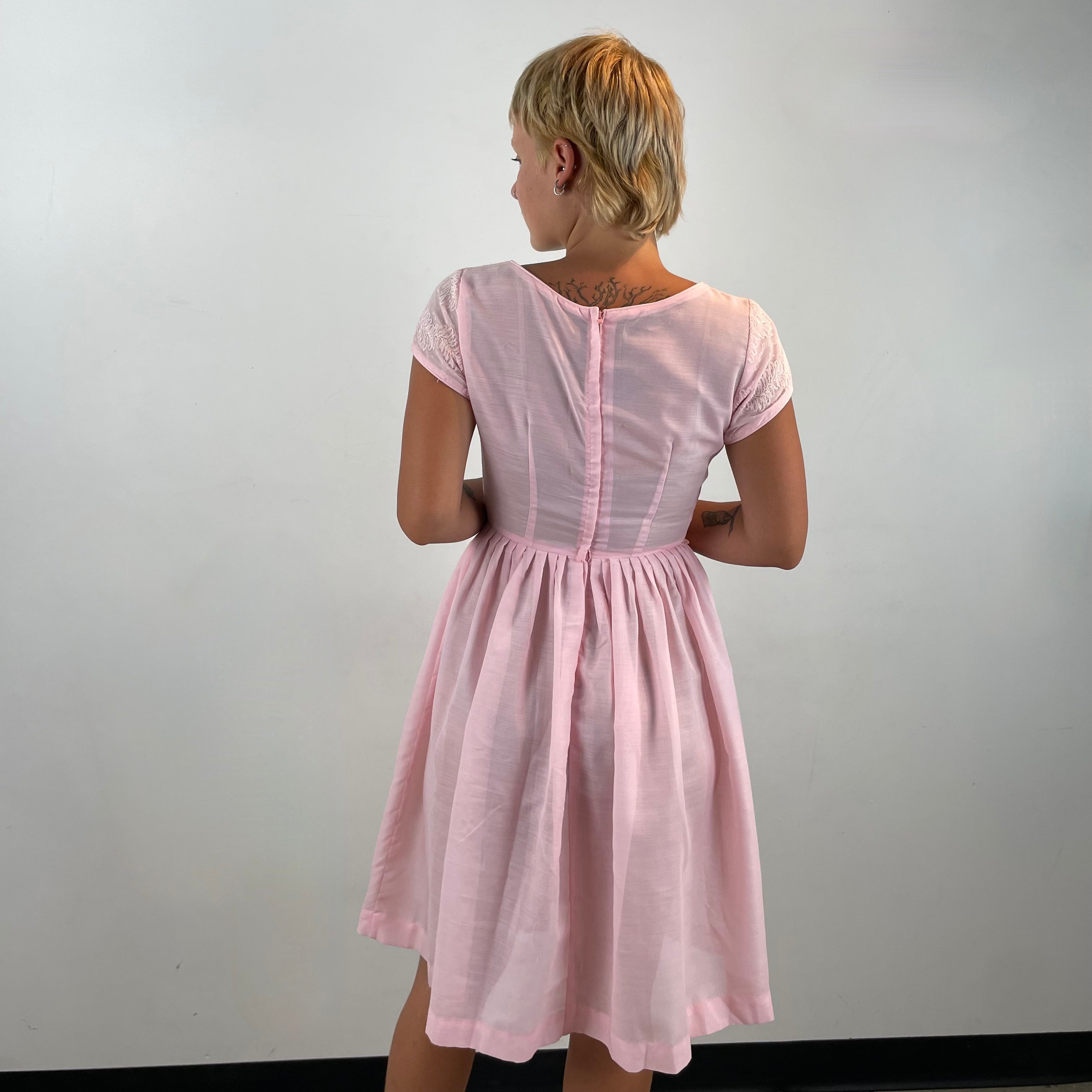 Boheme Vintage 1950s handmade pink lace fit and flare dress with pleated full skirt and short sleeves.