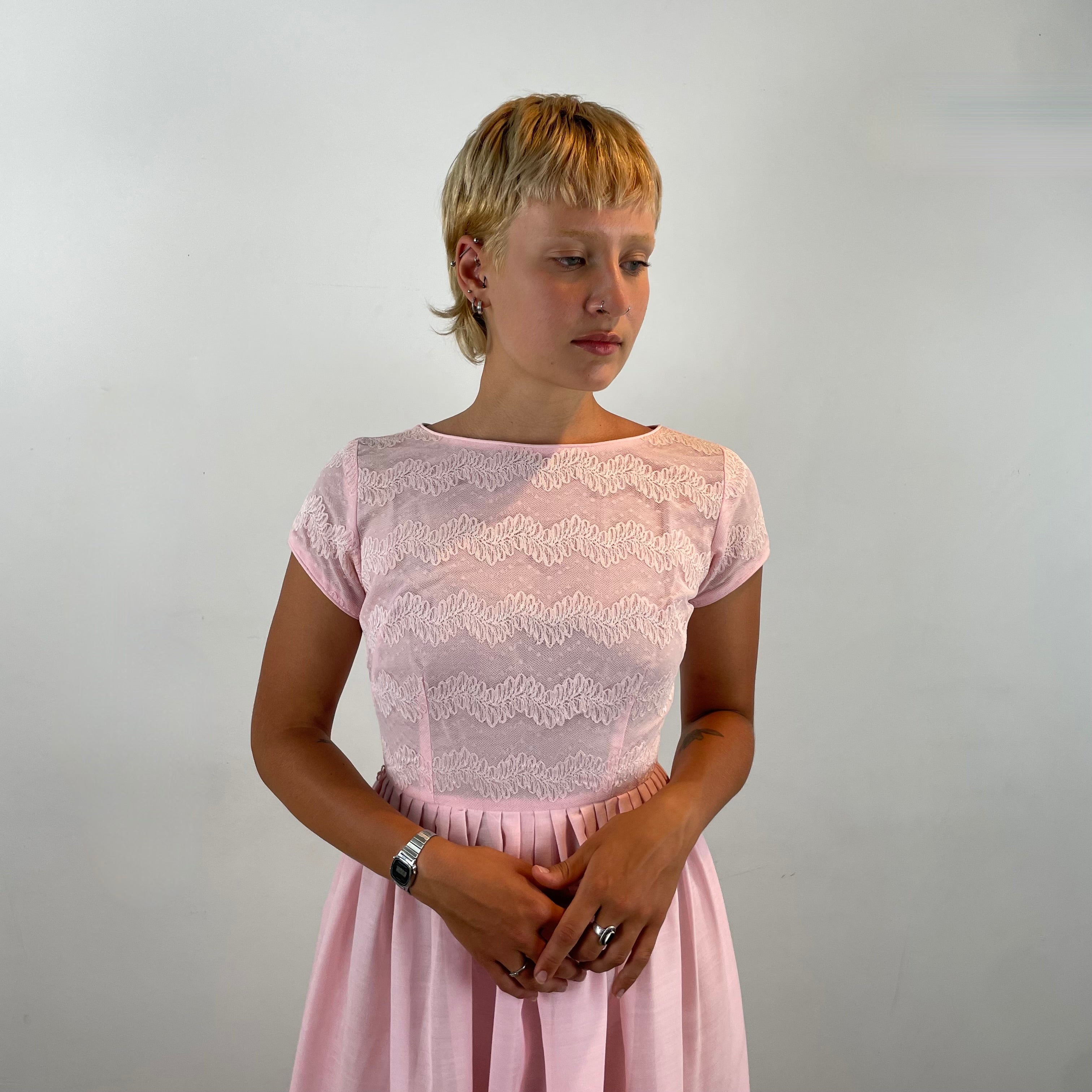 Boheme Vintage 1950s handmade pink lace fit and flare dress with pleated full skirt and short sleeves.