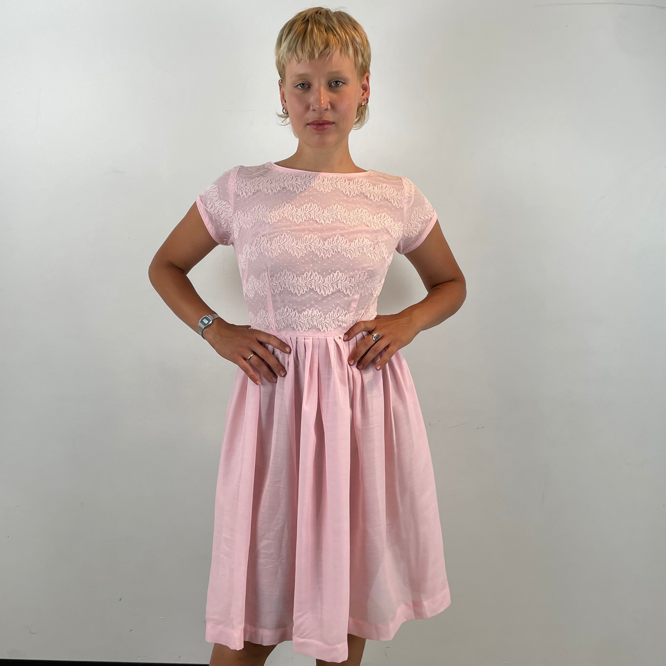 Boheme Vintage 1950s handmade pink lace fit and flare dress with pleated full skirt and short sleeves.