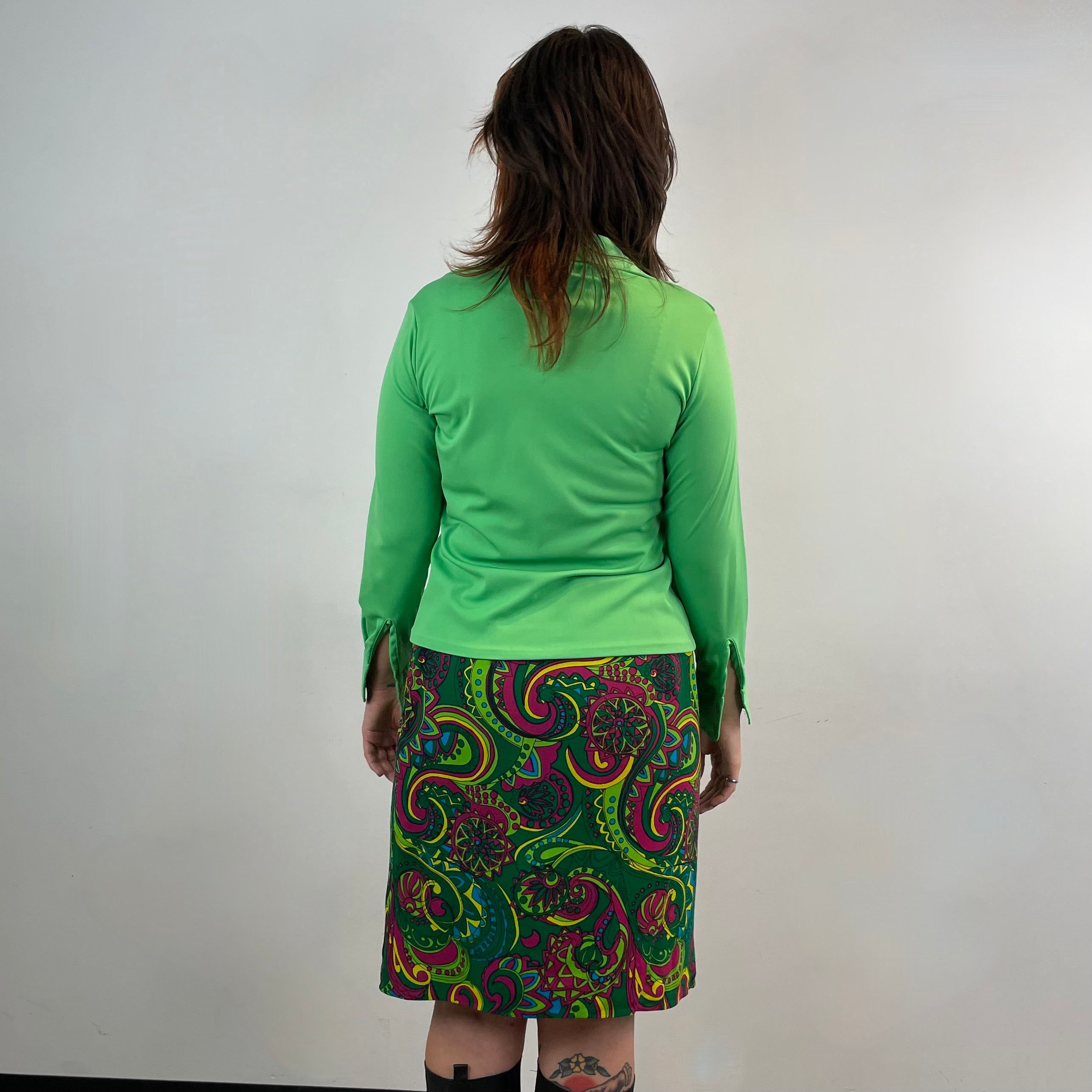 Vintage 1960s handmade skirt with a bold colorful psychedelic paisley print, straight cut, fitted hips, acetate lining and side metal zipper.