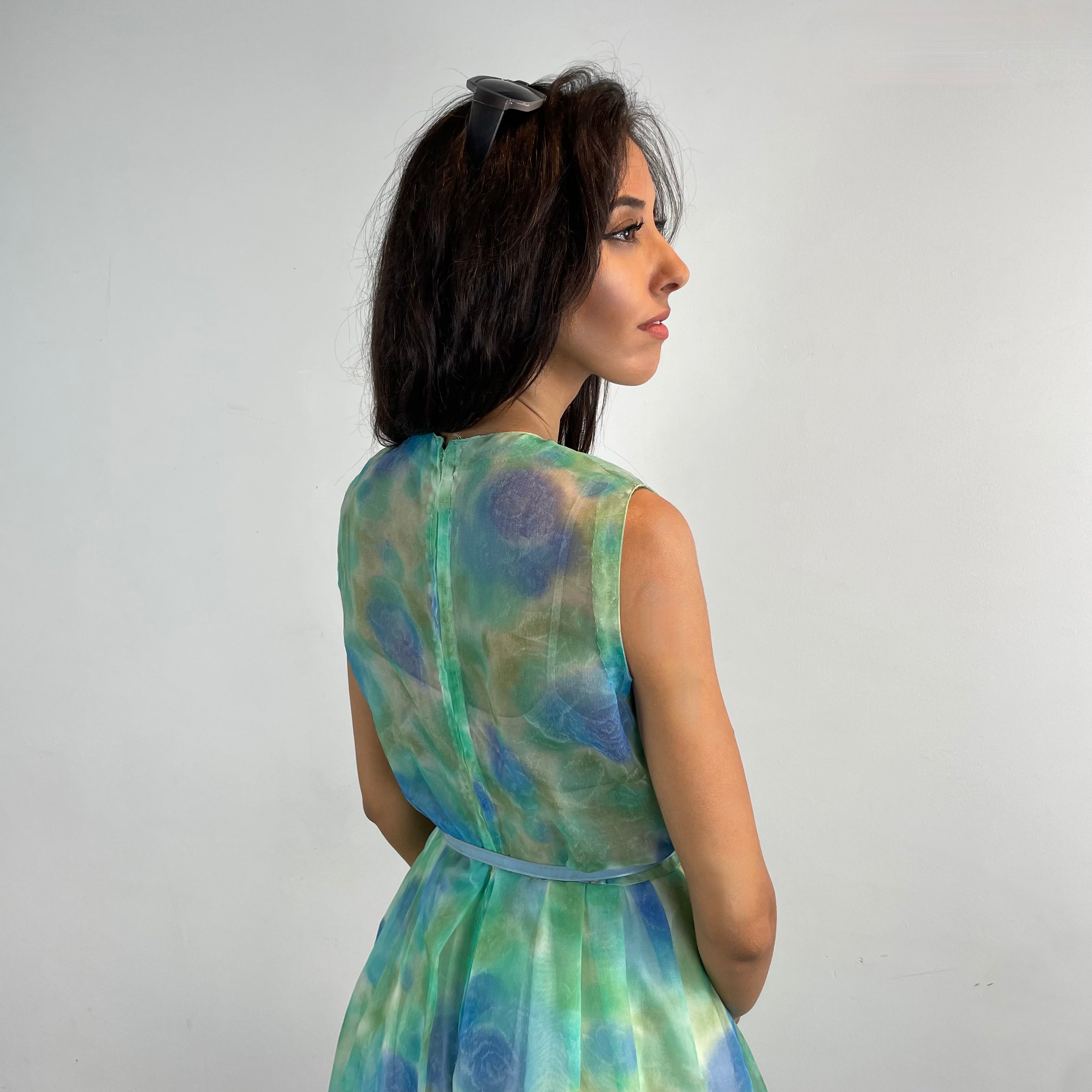Close Up Back View of Boheme Vintage 1960s handmade floral culotte dress with sheer organza fabric, pleated wide-leg culottes, and cache-coeur neckline.
