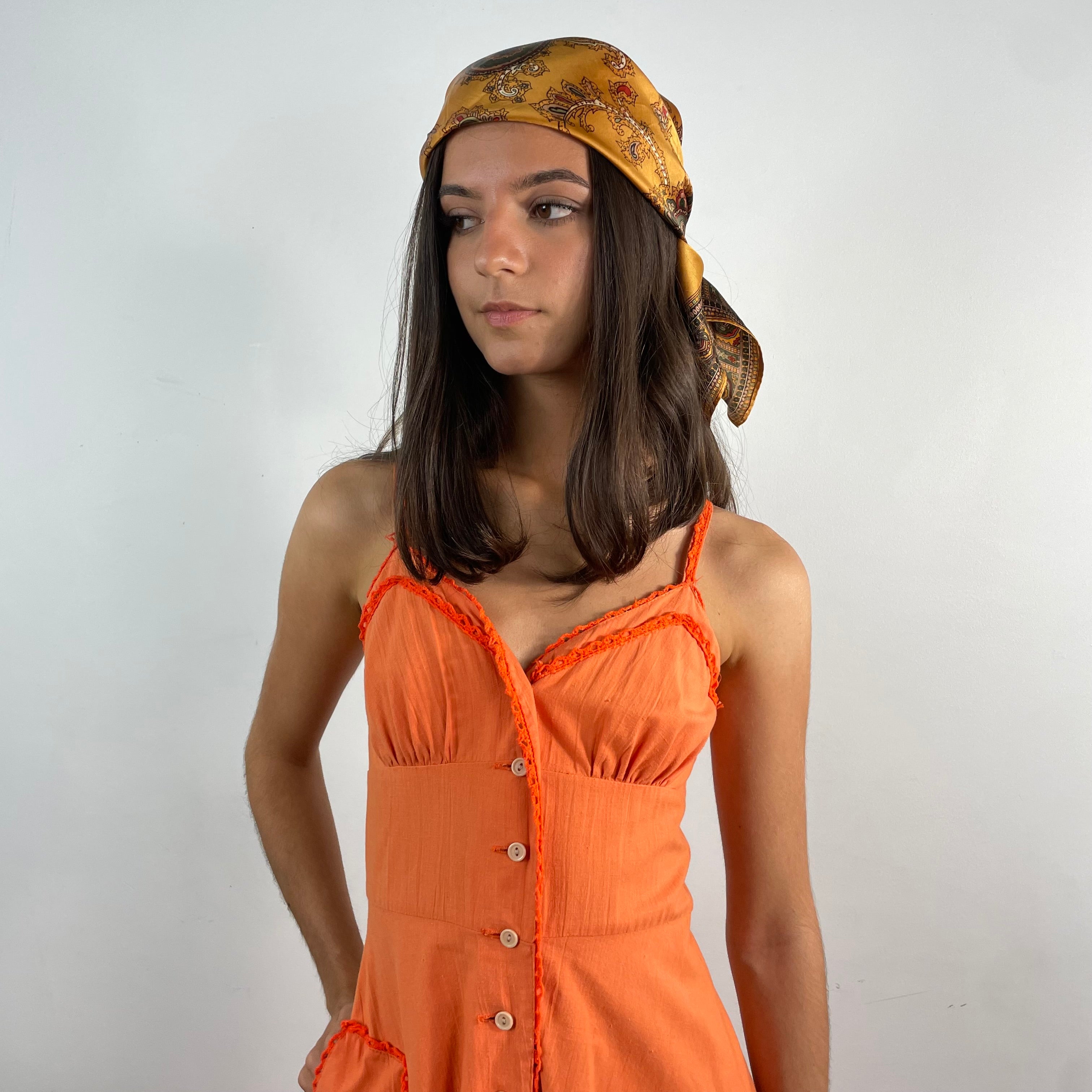Boheme Vintage 1970s orange cotton empire waist maxi dress with crochet trim, front buttons, flared skirt, and patch pocket.