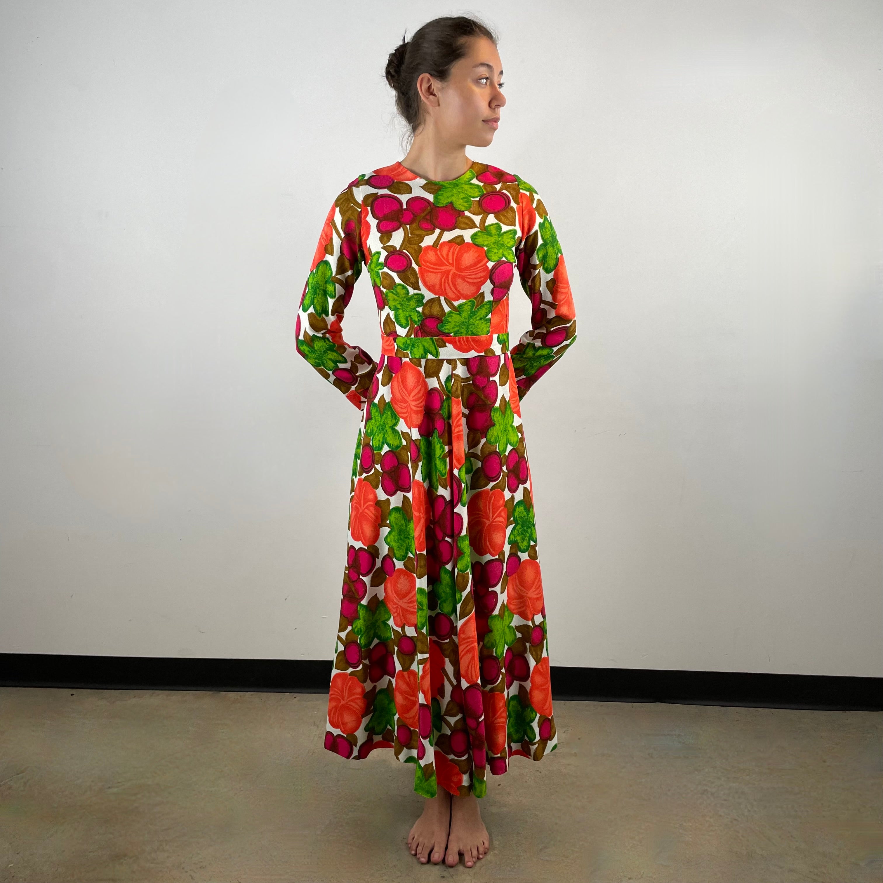Vintage 1970s handmade long-sleeve dress in textured canvas-style fabric with bold artistic designs, fitted bodice, flared skirt and matching belt.