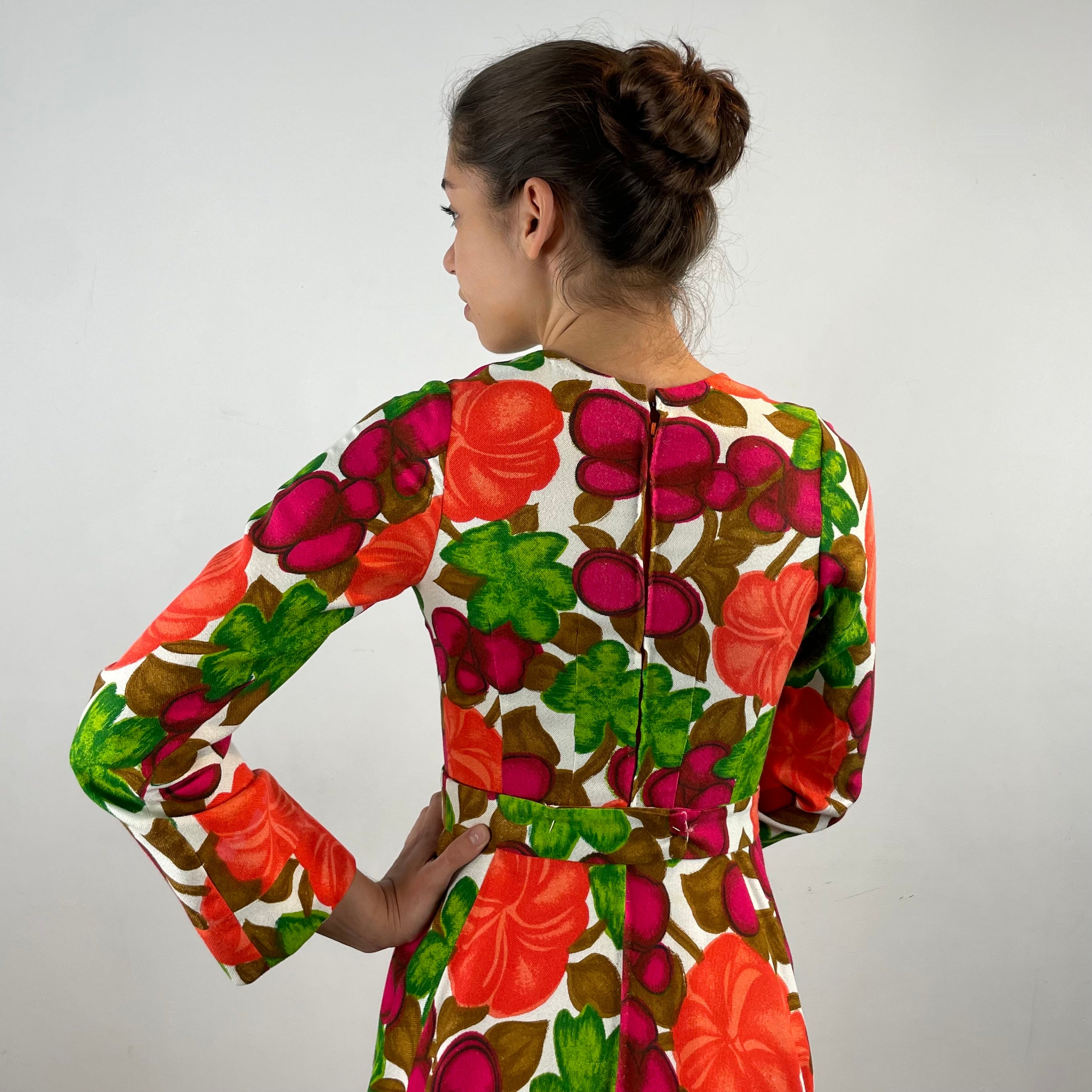 Vintage 1970s handmade long-sleeve dress in textured canvas-style fabric with bold artistic designs, fitted bodice, flared skirt and matching belt.