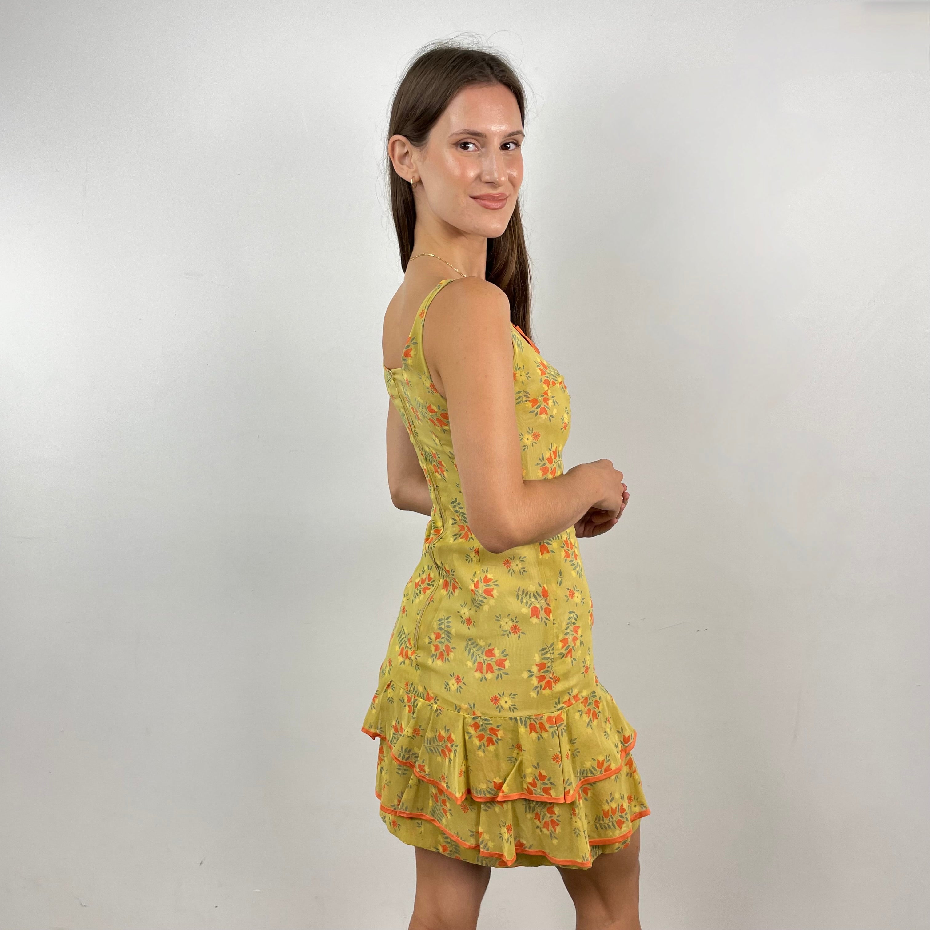 Boheme Vintage 1970s handmade sheath dress with scoop neckline, bow detail, and flounced hem.