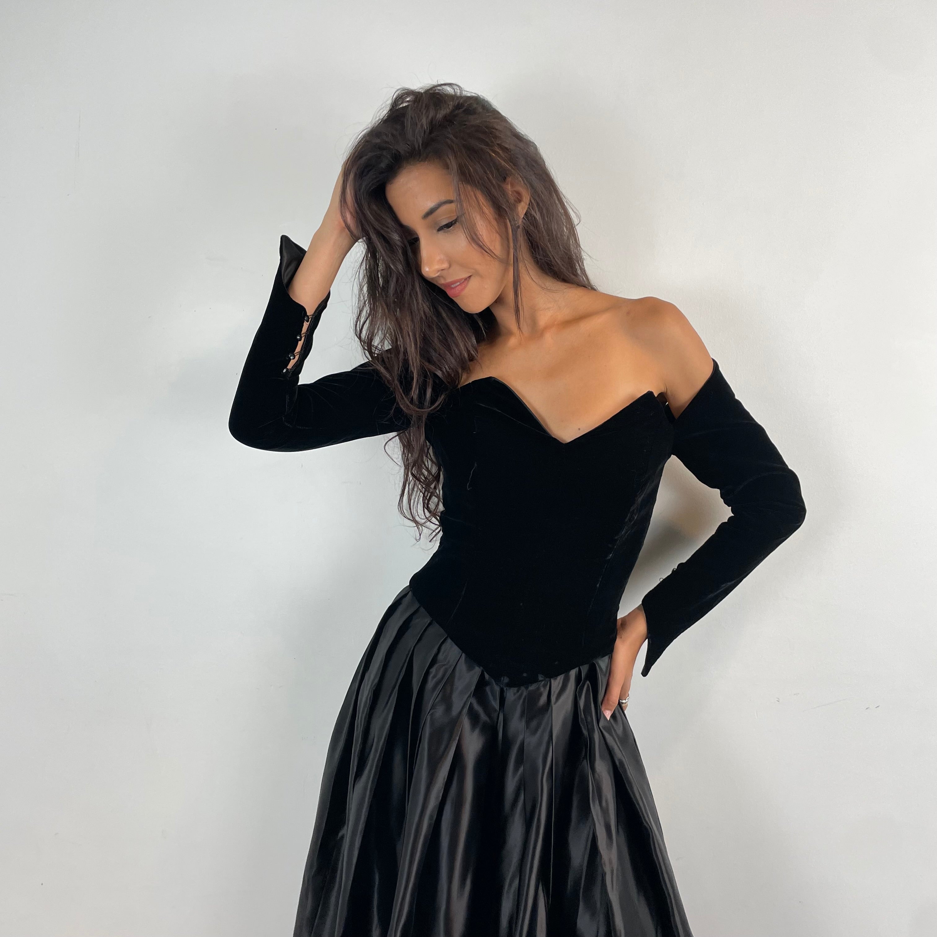 Front view of 1980s/90s Off-The-Shoulder Long Sleeve Black Bustier Midi Dress Size Small sold at bohemevintage.com Montreal