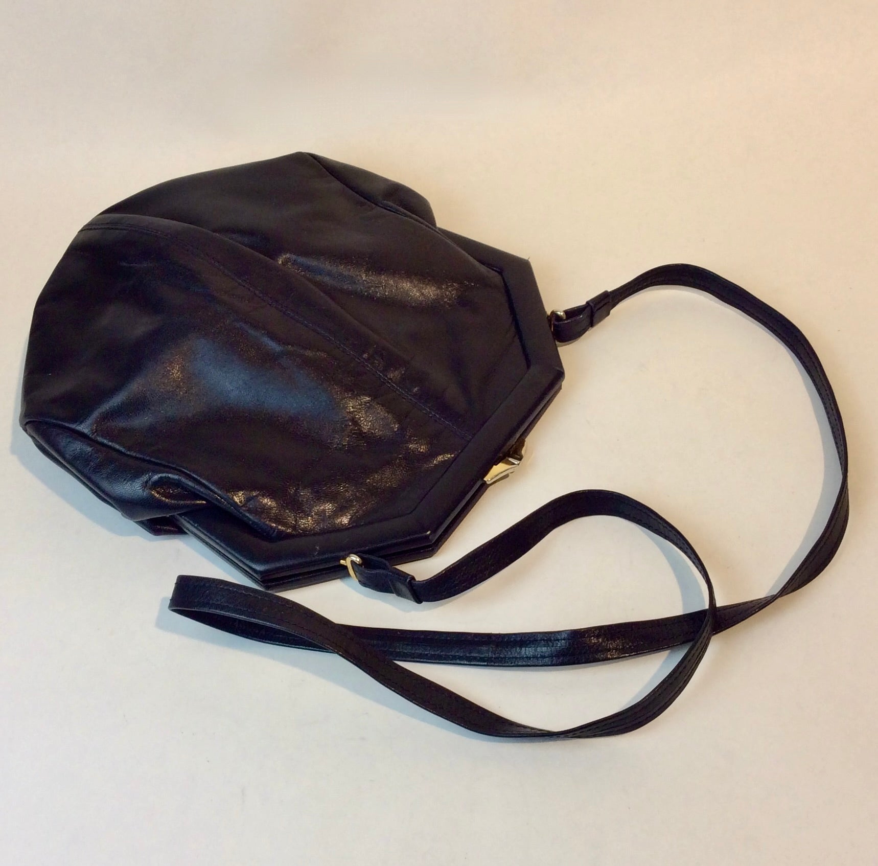 1980s Bruno Magli navy leather handbag with octagonal shape and gold push-lock closure, styled for shoulder or crossbody at Boheme Vintage in Montreal — bohemevintage.com