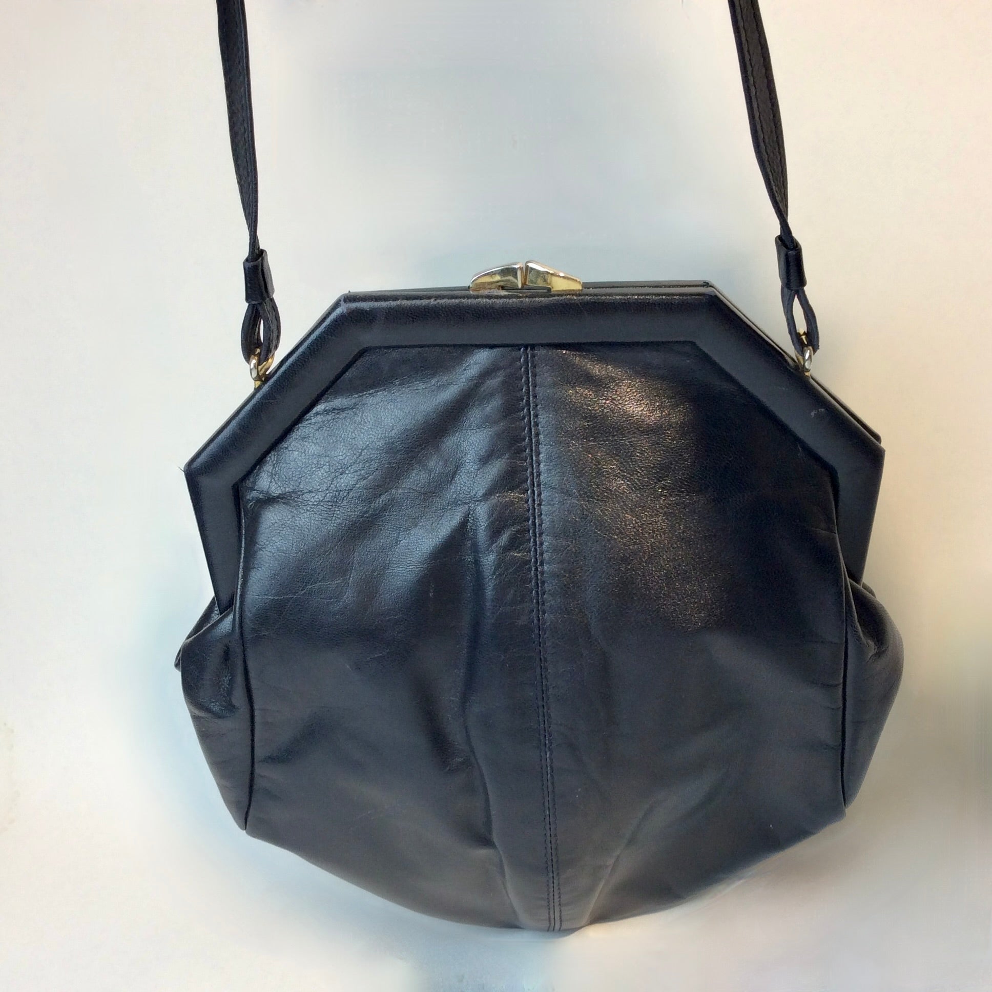 1980s Bruno Magli navy leather handbag with octagonal shape and gold push-lock closure, styled for shoulder or crossbody at Boheme Vintage in Montreal — bohemevintage.com