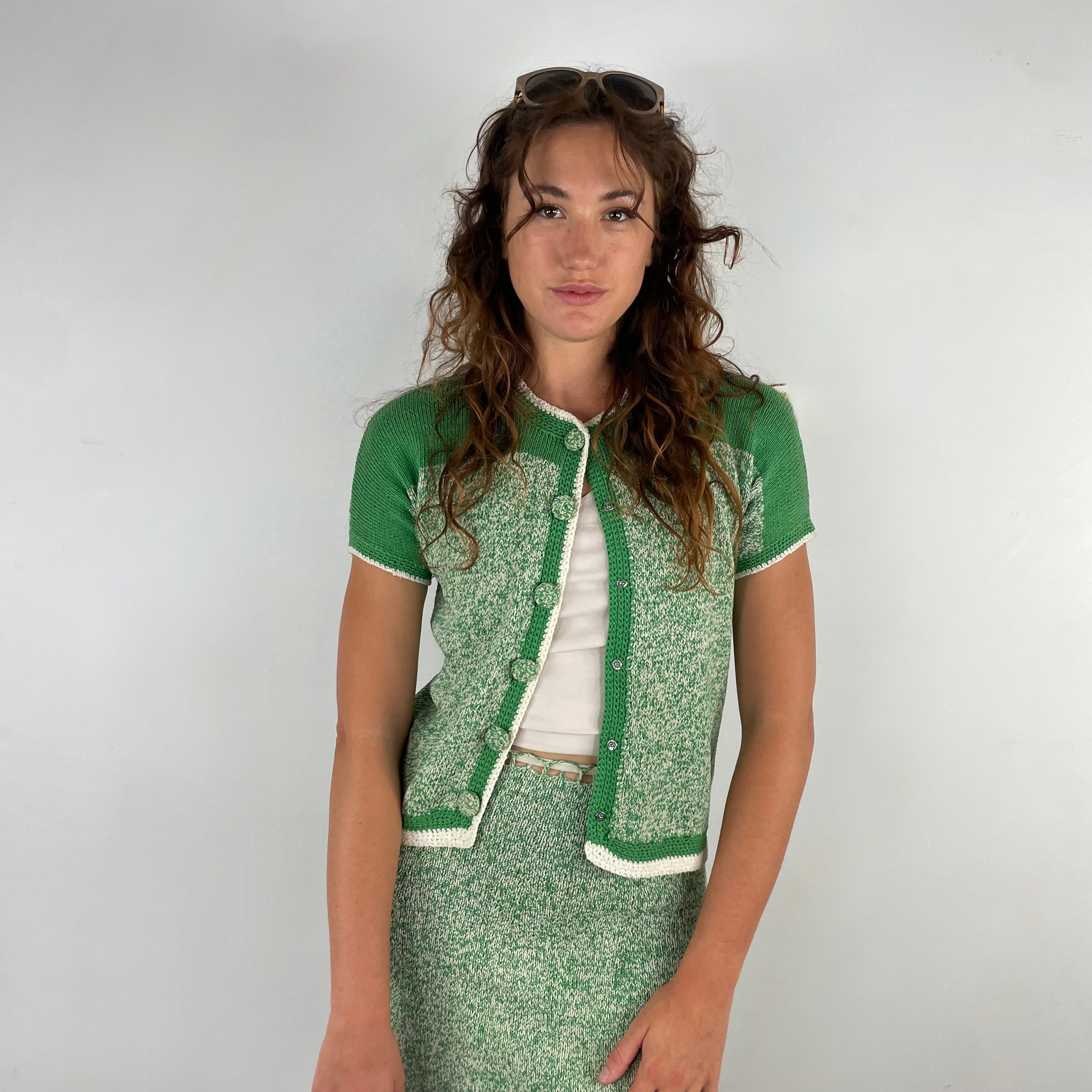 Close up front view of 1960s Green and White Knitted Cardigan and Skirt Set, with cardigan open
Size Small
Sold at bohemevintage.com
Montréal