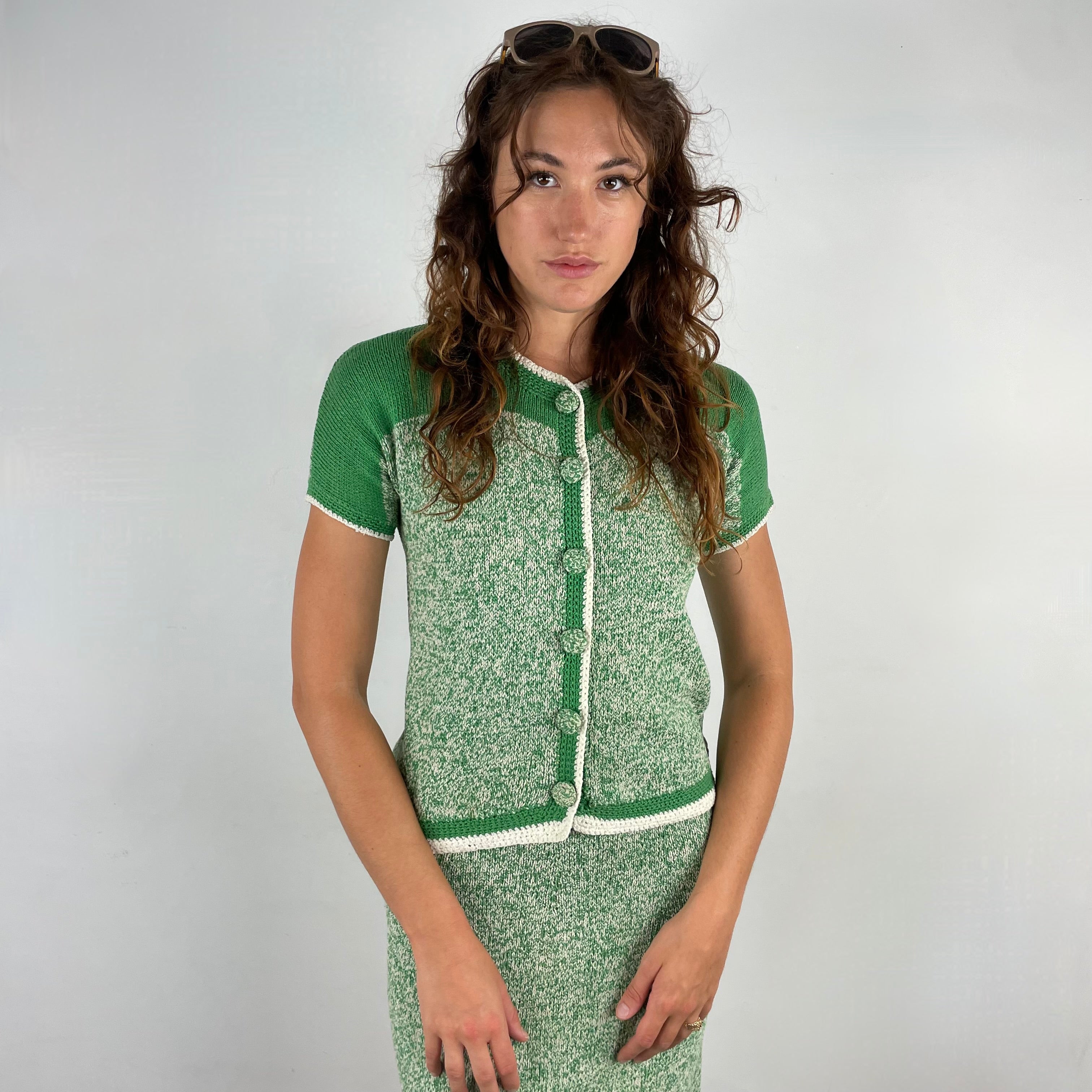 Close up front view of 1960s Green and White Knitted Cardigan and Skirt Set, with cardigan closed
Size Small
Sold at bohemevintage.com
Montréal