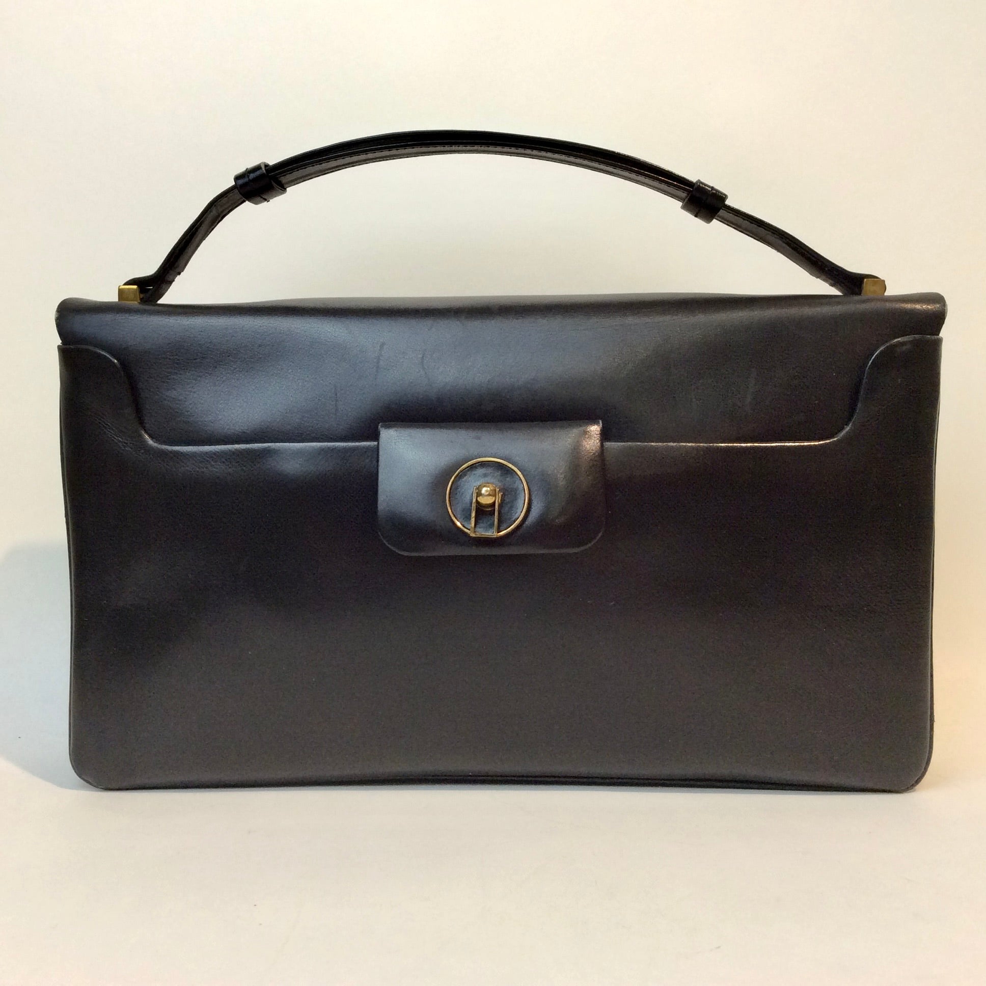 Vintage Art Deco leather handbag with unique closure and gold-tone hardware, available at Boheme Vintage, Montreal — bohemevintage.com