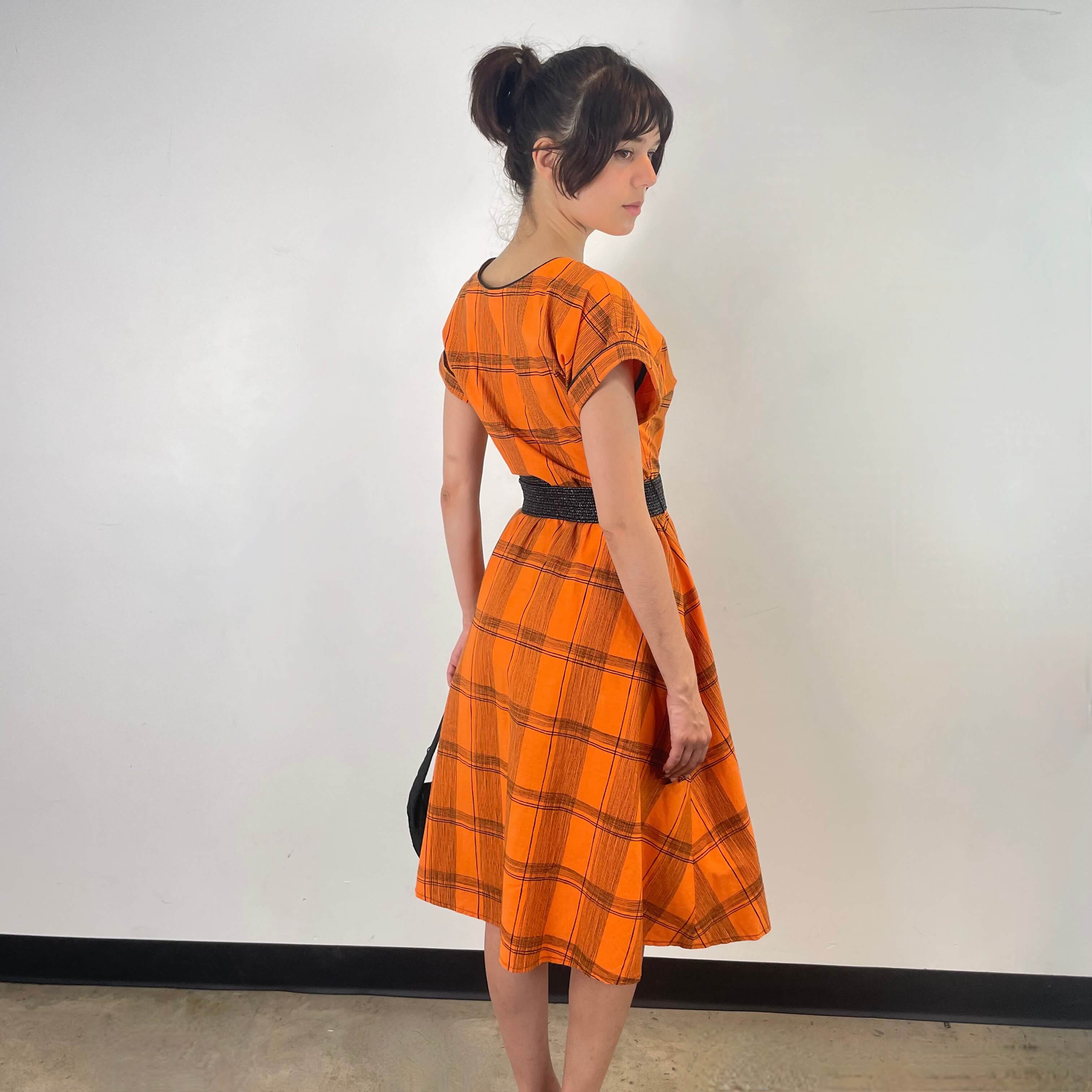 Back view of 1950s Orange Short Sleeve Buttoned-up Cotton Dress Size Small sold at bohemevintage.com Montreal