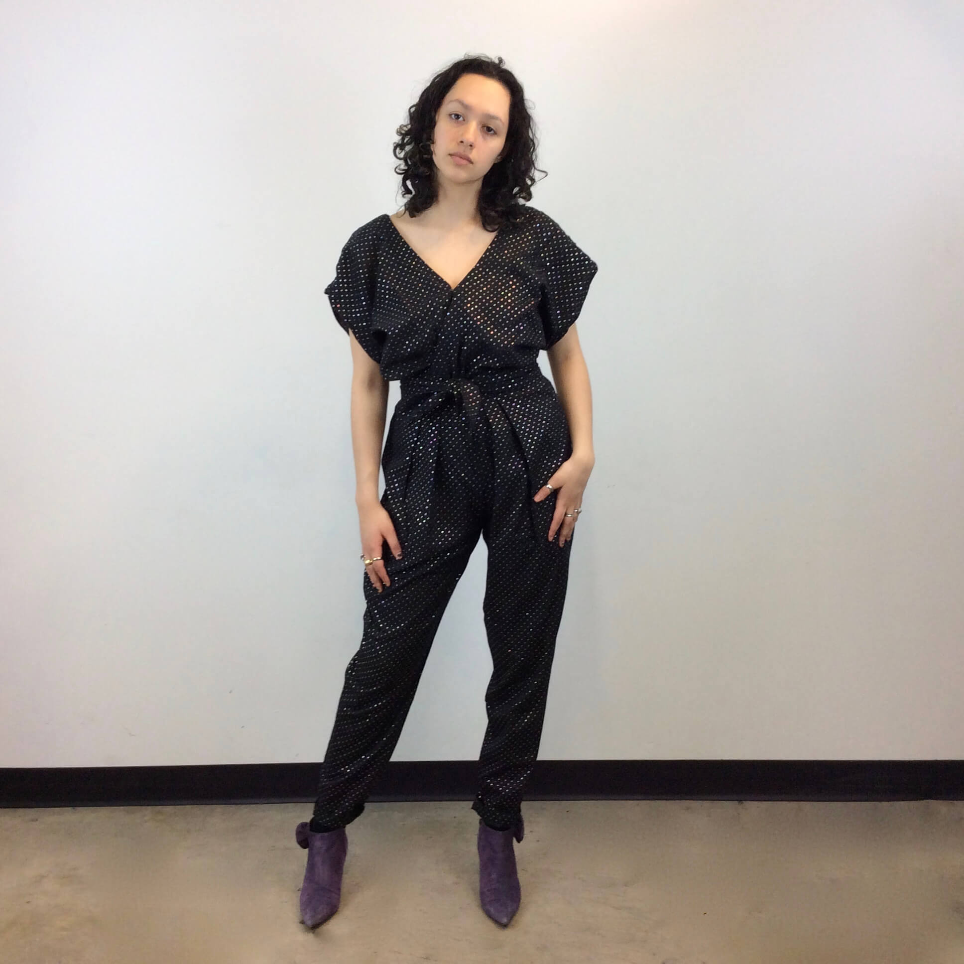 Front view of 1980s Gold Dotted Black Jumpsuit Size Small-Medium sold at bohemevintage.com Montreal