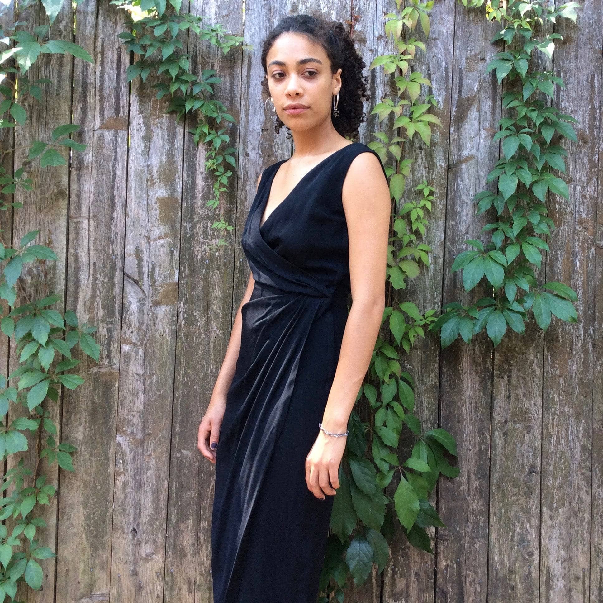 Front/side view of 1950s Black Maxi Sleeveless Wrapped Long Dress, size Small sold by bohemevintage.com Montreal