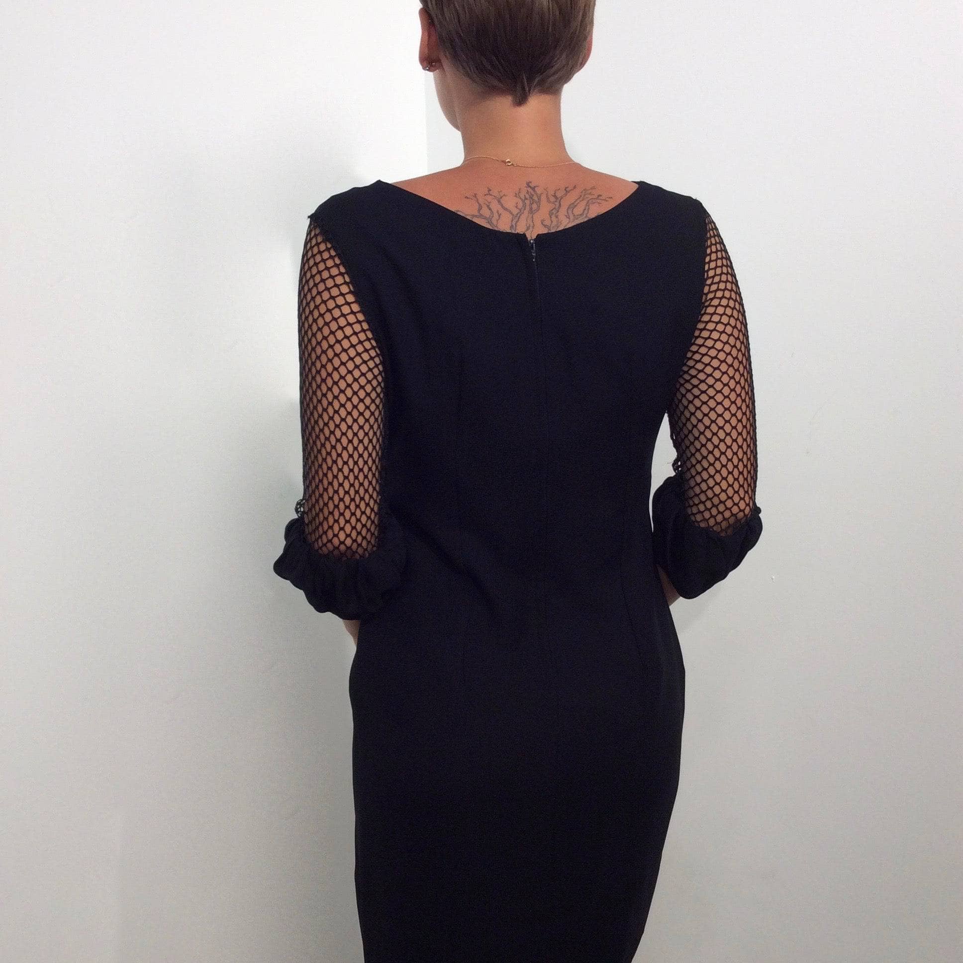 Back view of 1960s Black Mini Shift Dress with Mesh Sleeves size Small sold by bohemevintage.com Montréal