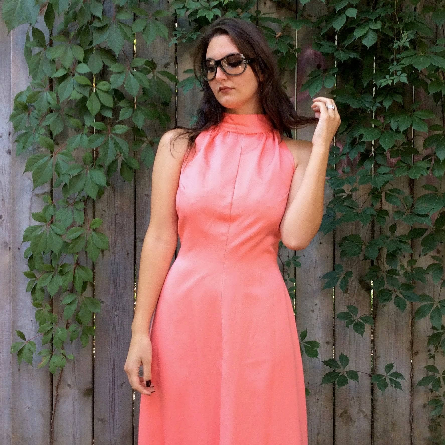 Close-up view of 1970s Handmade Coral Pink Floor-Length Sleeveless Gown Size small-Medium sold at bohemevintage.com MontreaL