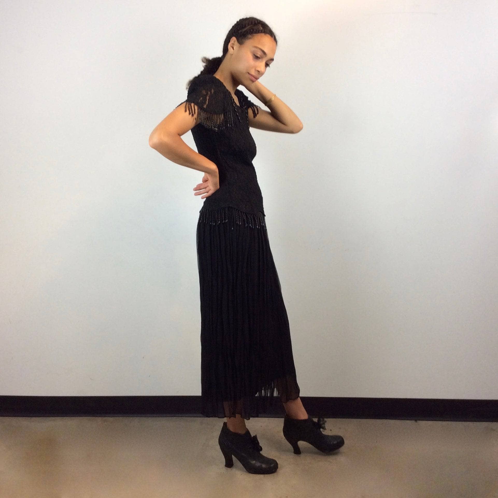 Side view of 1980s Black Short sleeve lace with beaded fringes Midi Dress Size Medium sold by bohemevintage.com Montreal