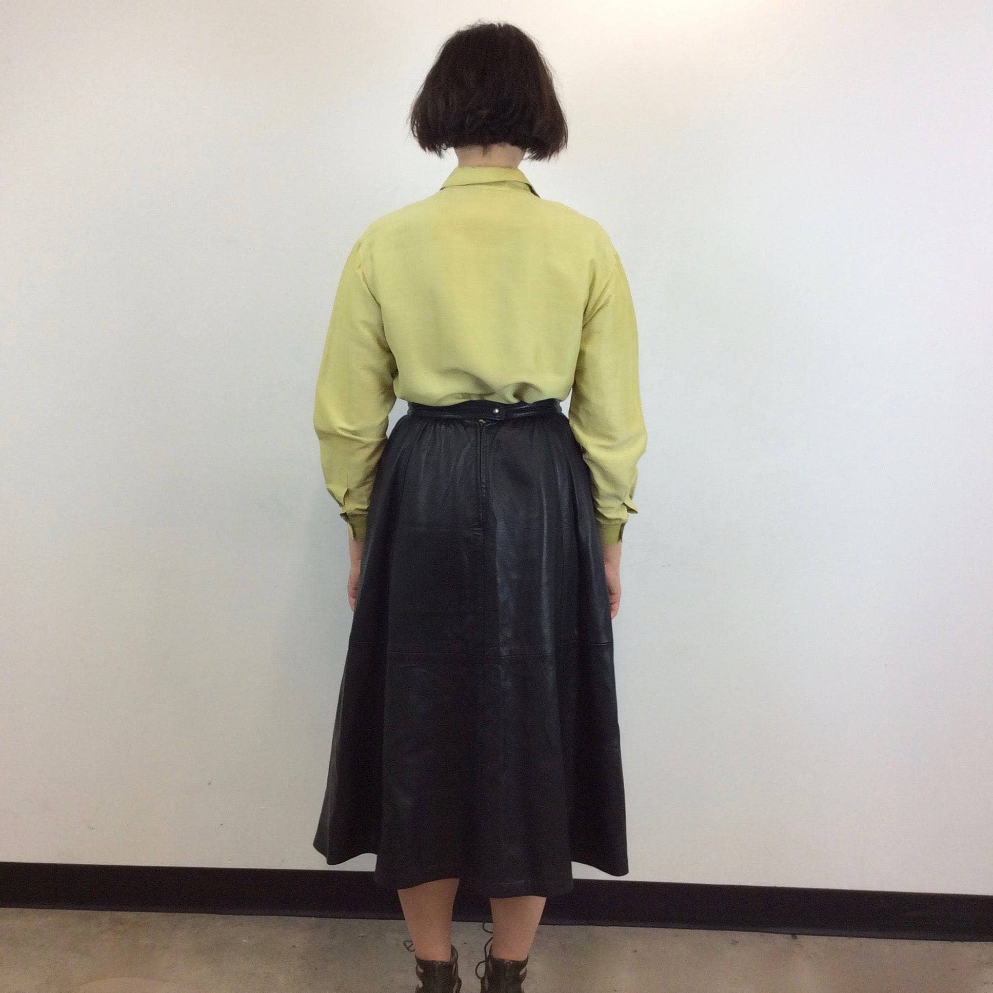 Back view of 1990s Burberrys Raw Silk Blouse Size Medium worn with a midi length A-line leather skirt sold by bohemevintage.com Montreal