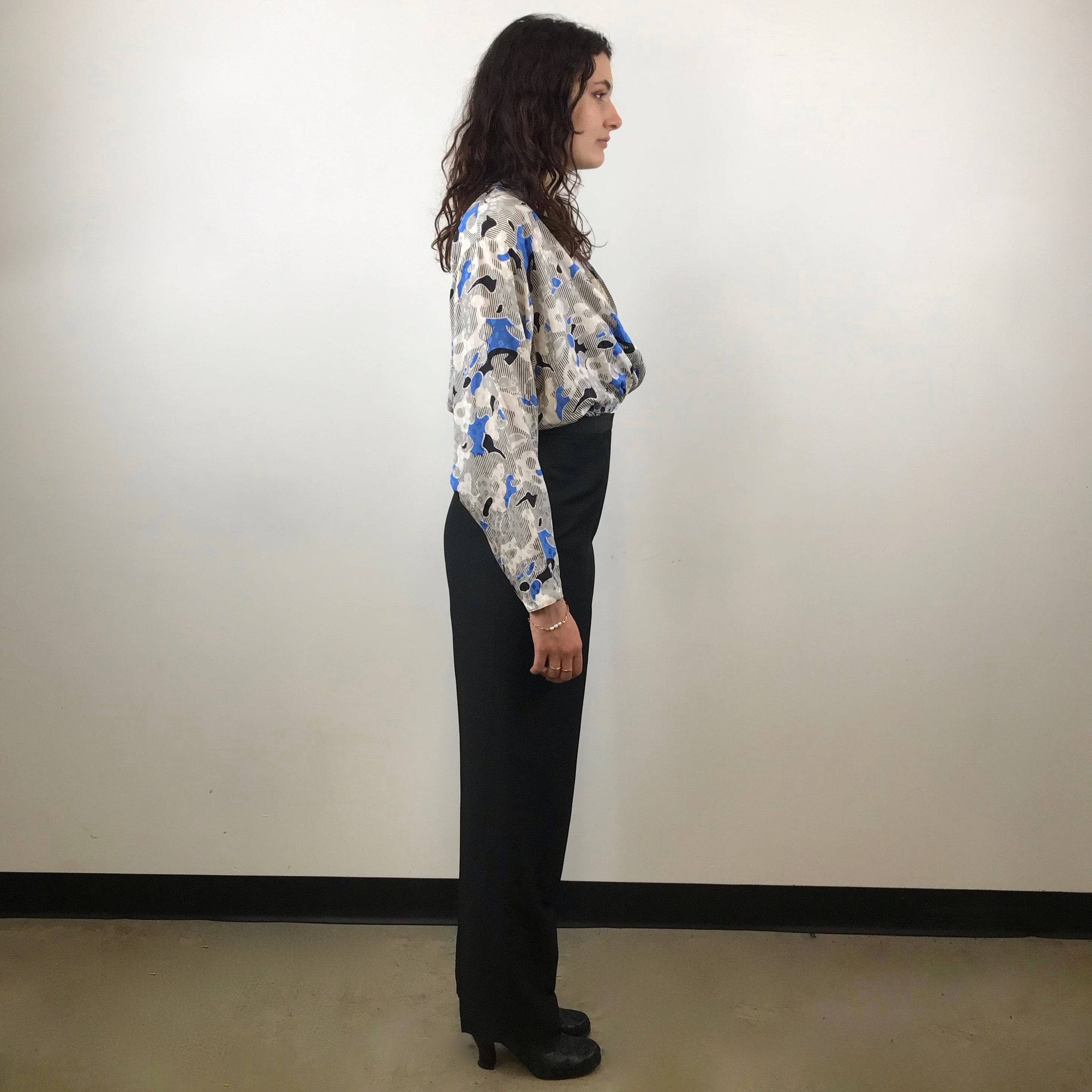 Side view of Emanuel Ungaro High-Waisted Tapered Leg Black Trousers size Medium paired with tucked in Guy Laroche french designer silk blouse sold by bohemevintage.com Montreal