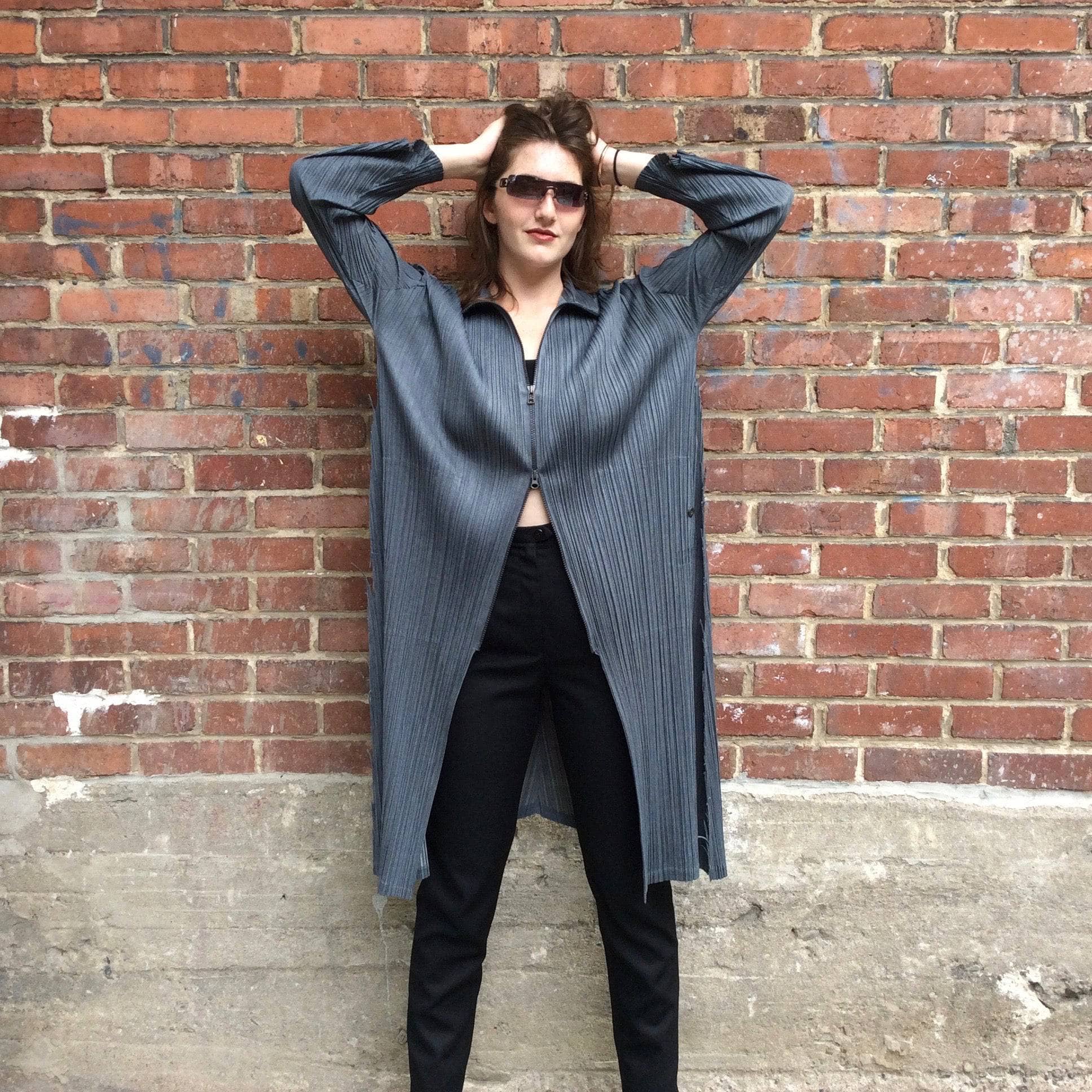 Partly zipped up Issey Miyake Long Asymmetrical Light-Weight charcoal grey Crinkle Coat, sold by bohemevintage.com Montréal