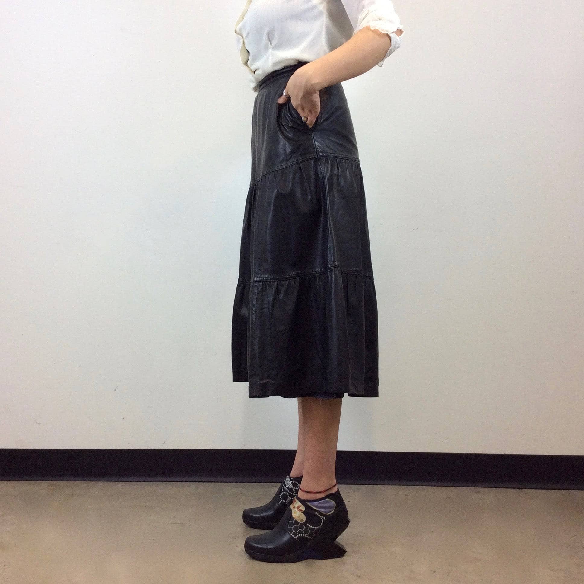 Side view of Back view of Leo Chevalier Tiered Black Leather Midi Skirt Size S/M sold by bohemevintage.com