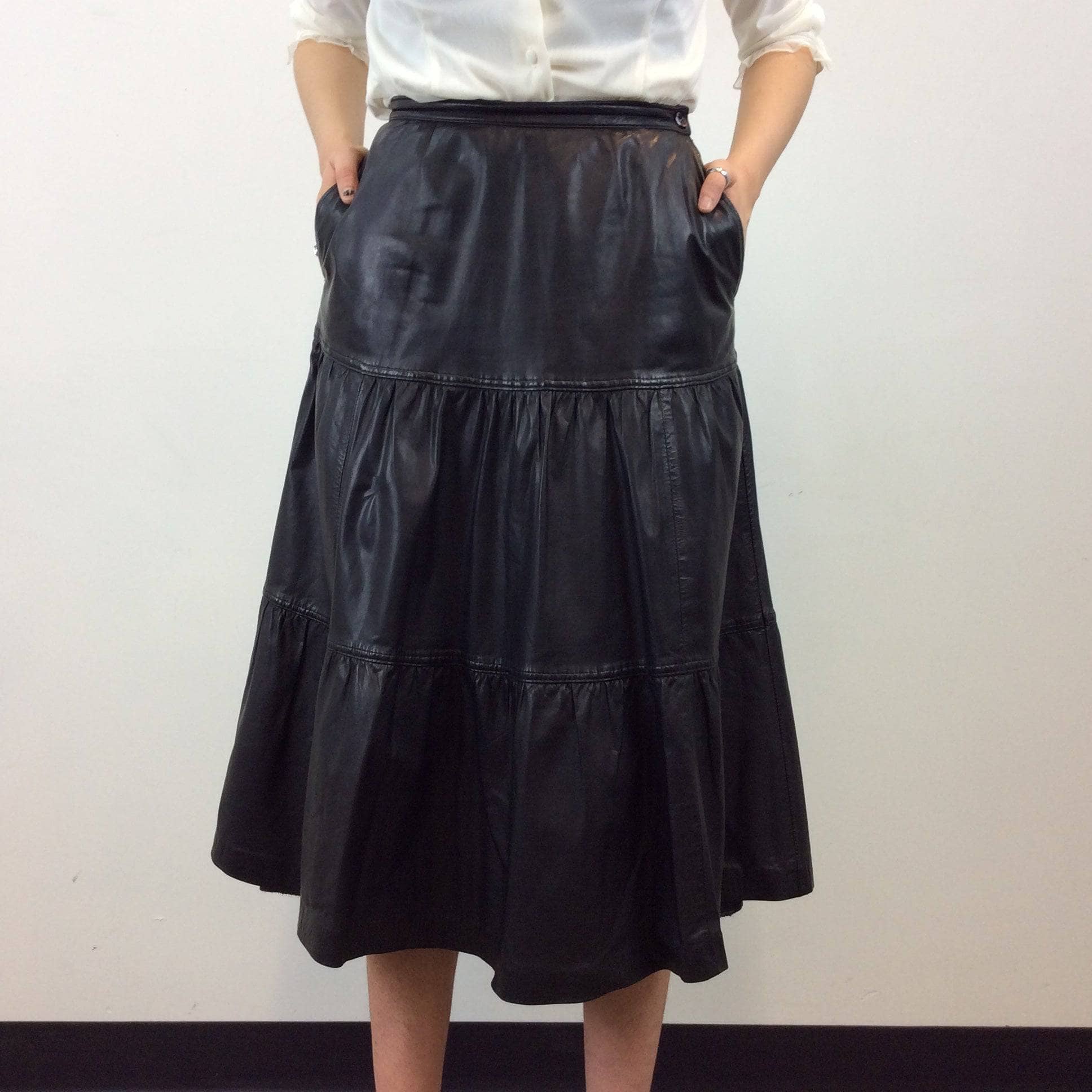 Back view of Leo Chevalier Tiered Black Leather Midi Skirt Size S/M sold by bohemevintage.com