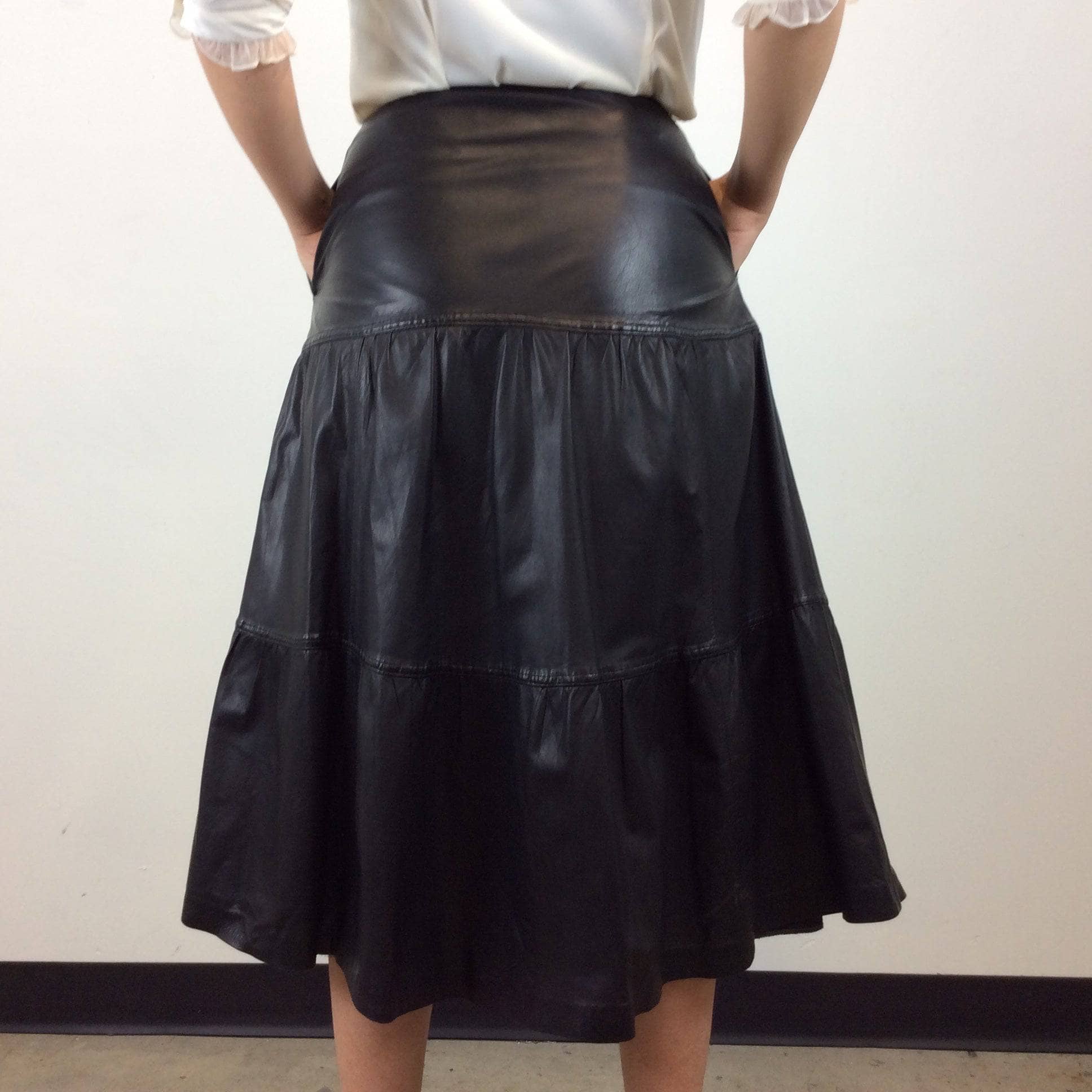 Back view of Leo Chevalier Tiered Black Leather Midi Skirt Size S/M sold by bohemevintage.com