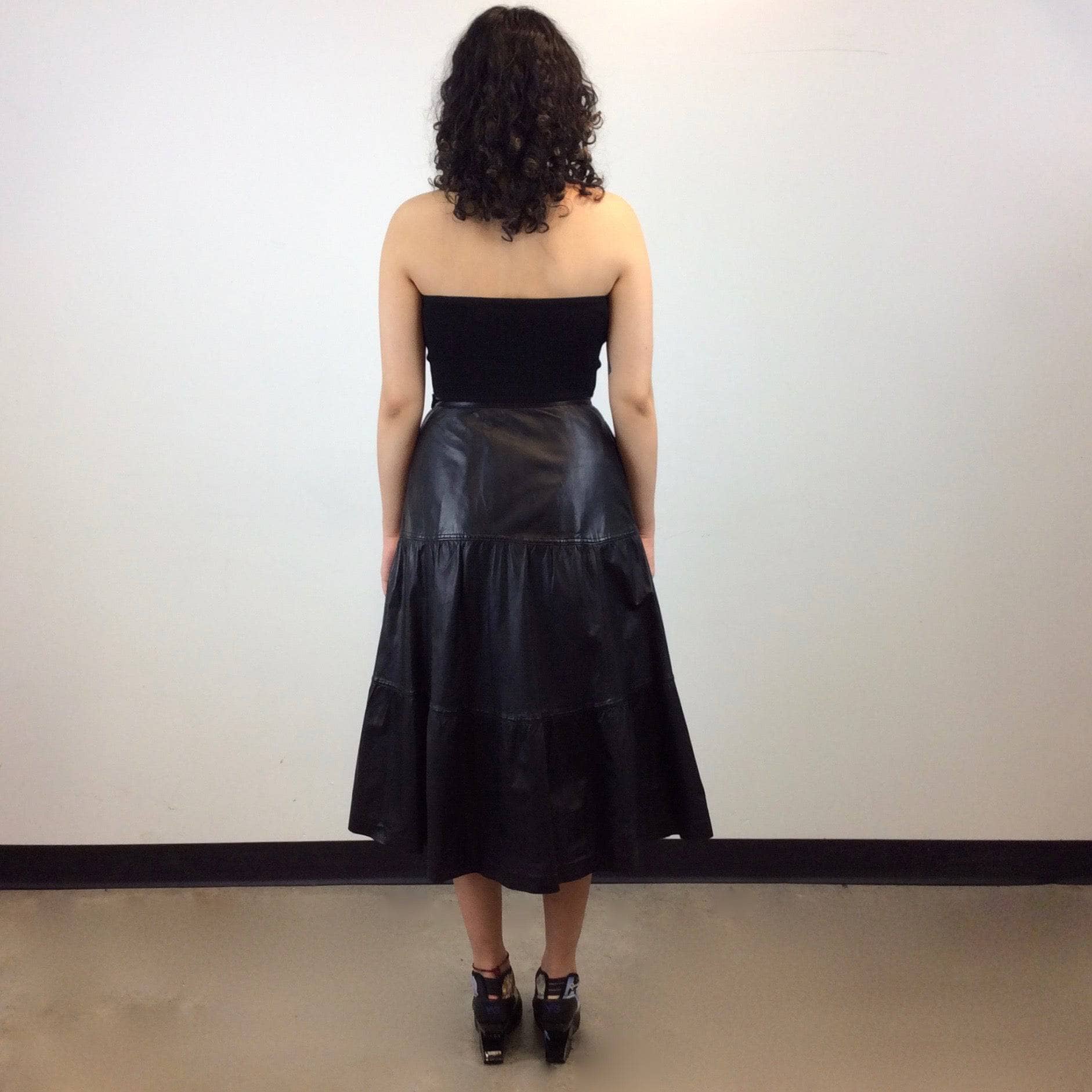 Back view of Leo Chevalier Tiered Black Leather Midi Skirt Size S/M sold by bohemevintage.com
