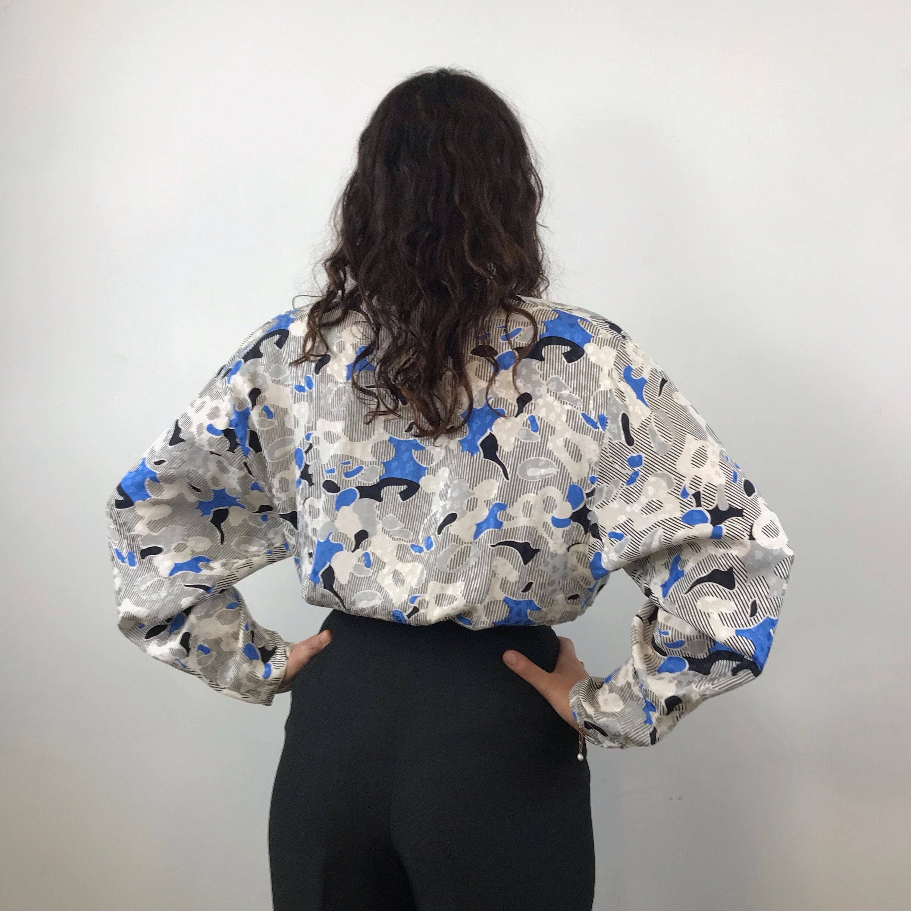 Close-up view of Tucked in Louis Féraud Wrap Silk Peplum Tunic Blouse size Medium-Large with Armani black high waisted trousers sold by bohemevintage.com