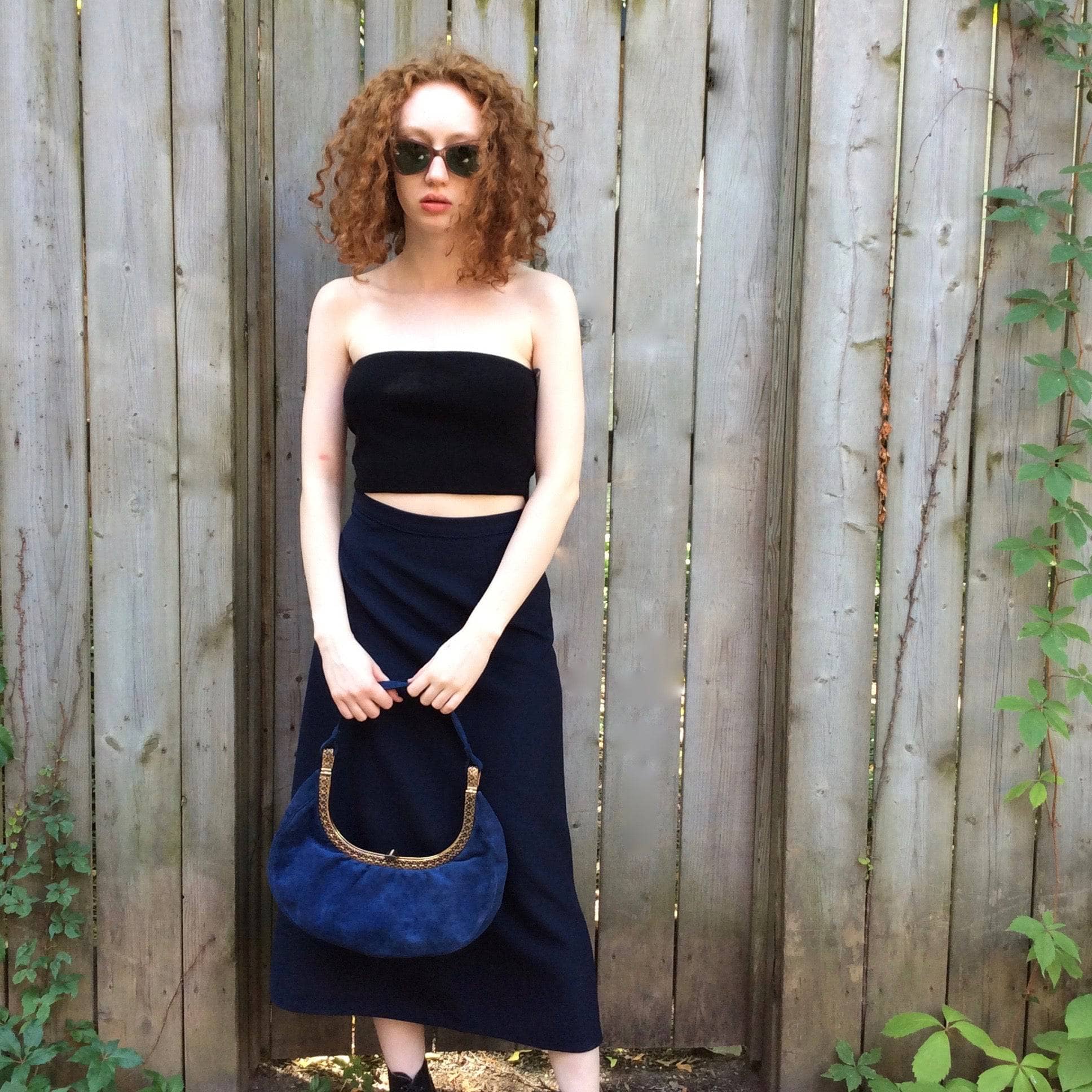 1950s Blue Suede Crescent Handbag with Detailed Gold Frame Koret Acc. Model is wearing Navy Blue A-Line Skirt Sold at bohemevintage.com Montréal