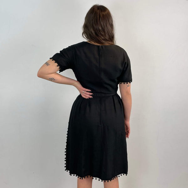 Back view of 1950s Black Short-Sleeve Cocktail Dress size medium sold at bohemevintage.com Montreal