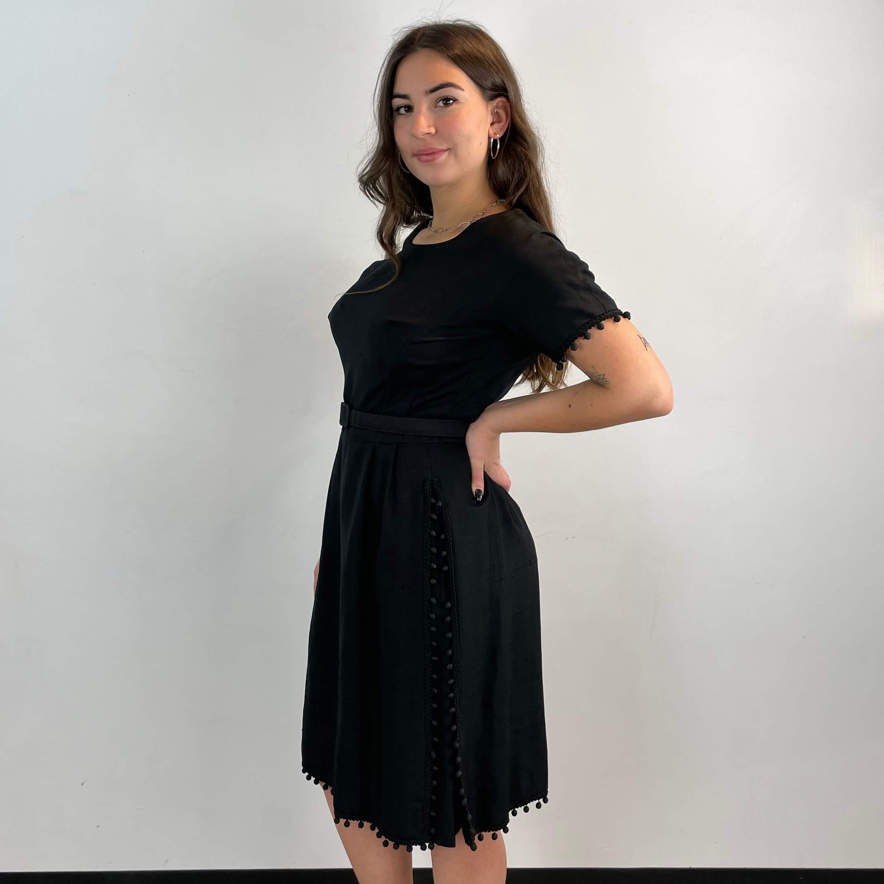 Side view of 1950s Black Short-Sleeve Cocktail Dress size medium sold at bohemevintage.com Montreal