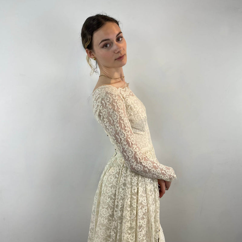Side view of 1950s Ivory Long Sleeve Lace Dress size Extra-Small/Small sold at bohemevintage.com Montreal
