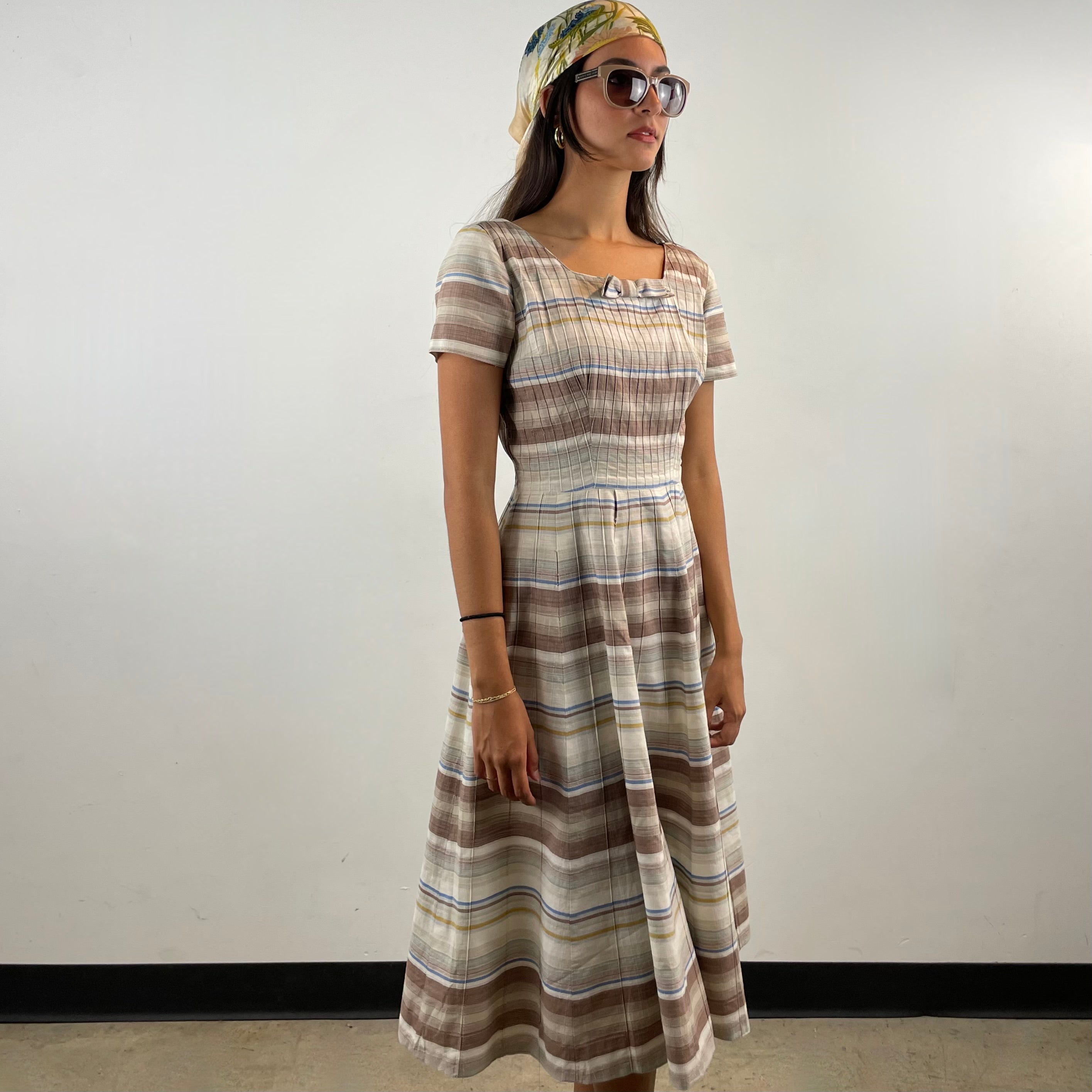 Vintage 1970s brown and cream striped maxi dress with green and blue bands, textured cotton fabric, fitted bodice, short sleeves and flared skirt.