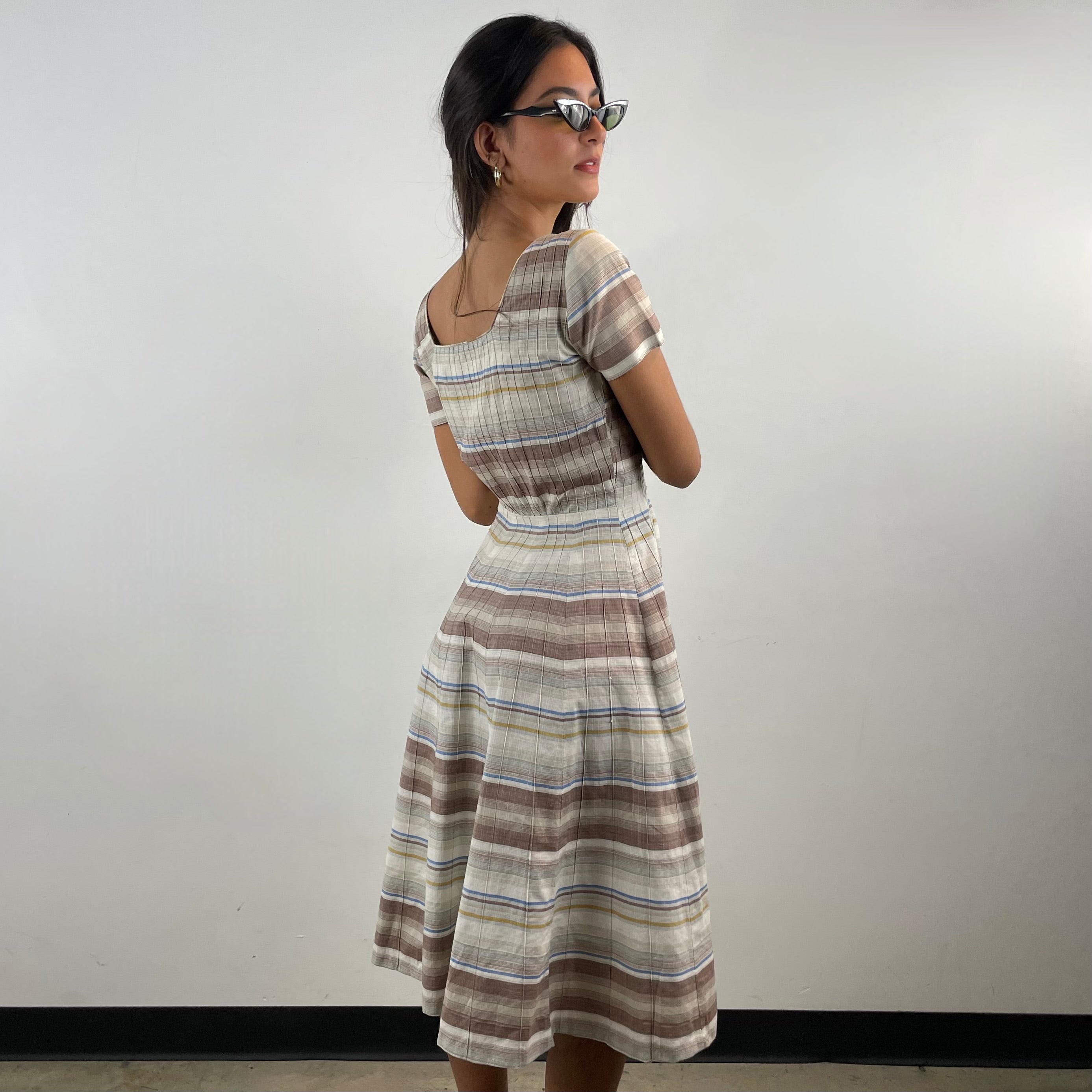 Vintage 1970s brown and cream striped maxi dress with green and blue bands, textured cotton fabric, fitted bodice, short sleeves and flared skirt.