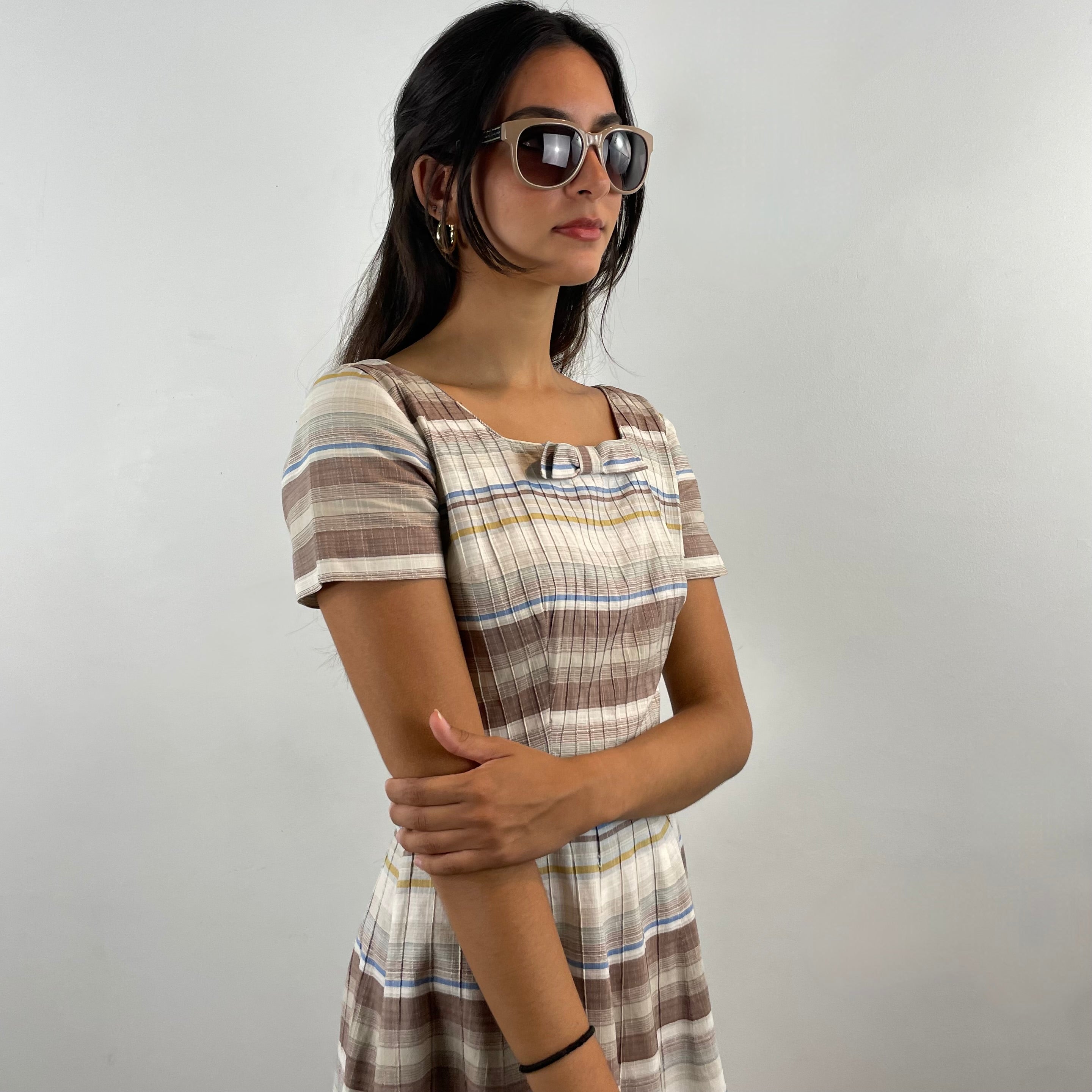 Vintage 1970s brown and cream striped maxi dress with green and blue bands, textured cotton fabric, fitted bodice, short sleeves and flared skirt.