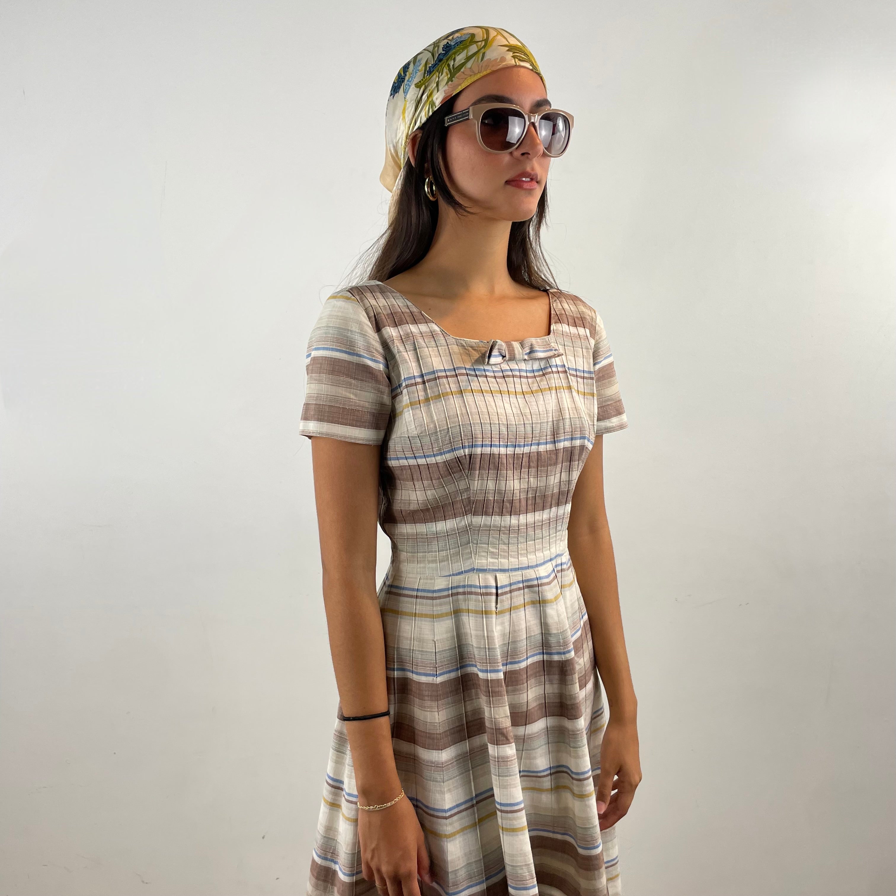 Vintage 1970s brown and cream striped maxi dress with green and blue bands, textured cotton fabric, fitted bodice, short sleeves and flared skirt.