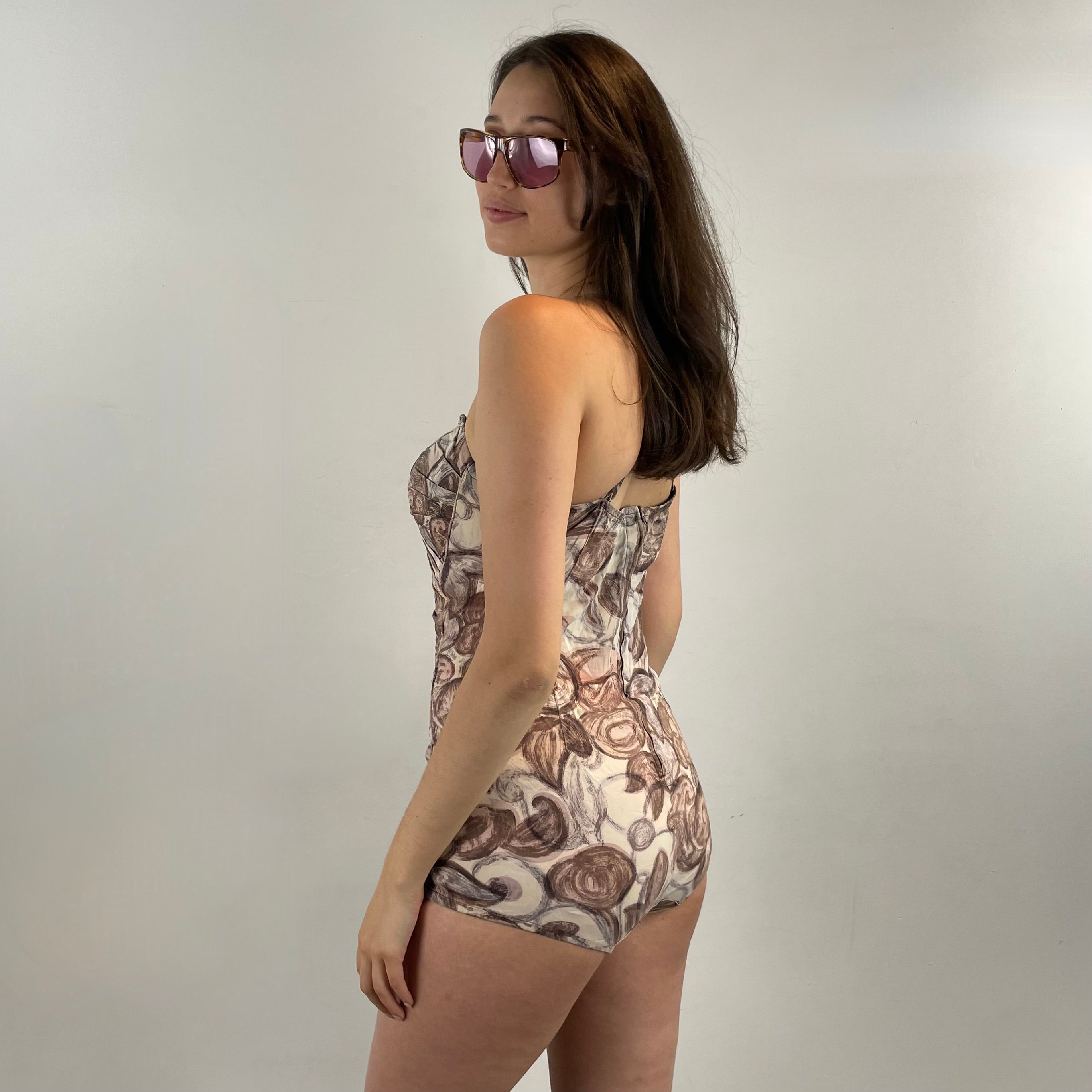 Boheme Vintage 1950s floral ruched one-piece bathing suit with sweetheart neckline, adjustable straps, and skirted silhouette.