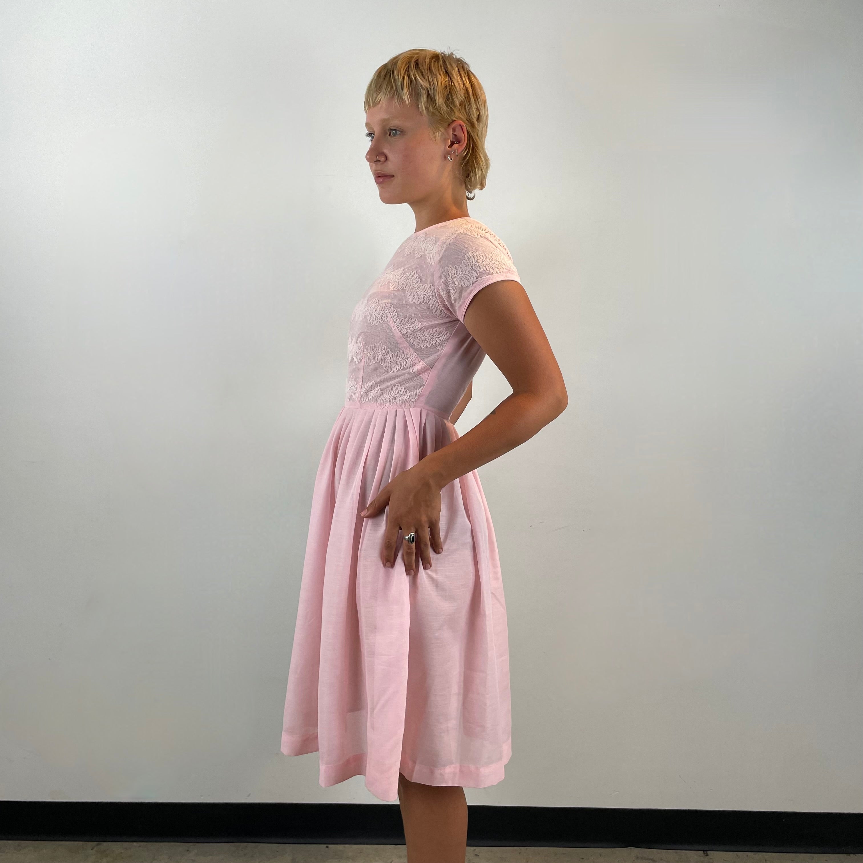 Boheme Vintage 1950s handmade pink lace fit and flare dress with pleated full skirt and short sleeves.