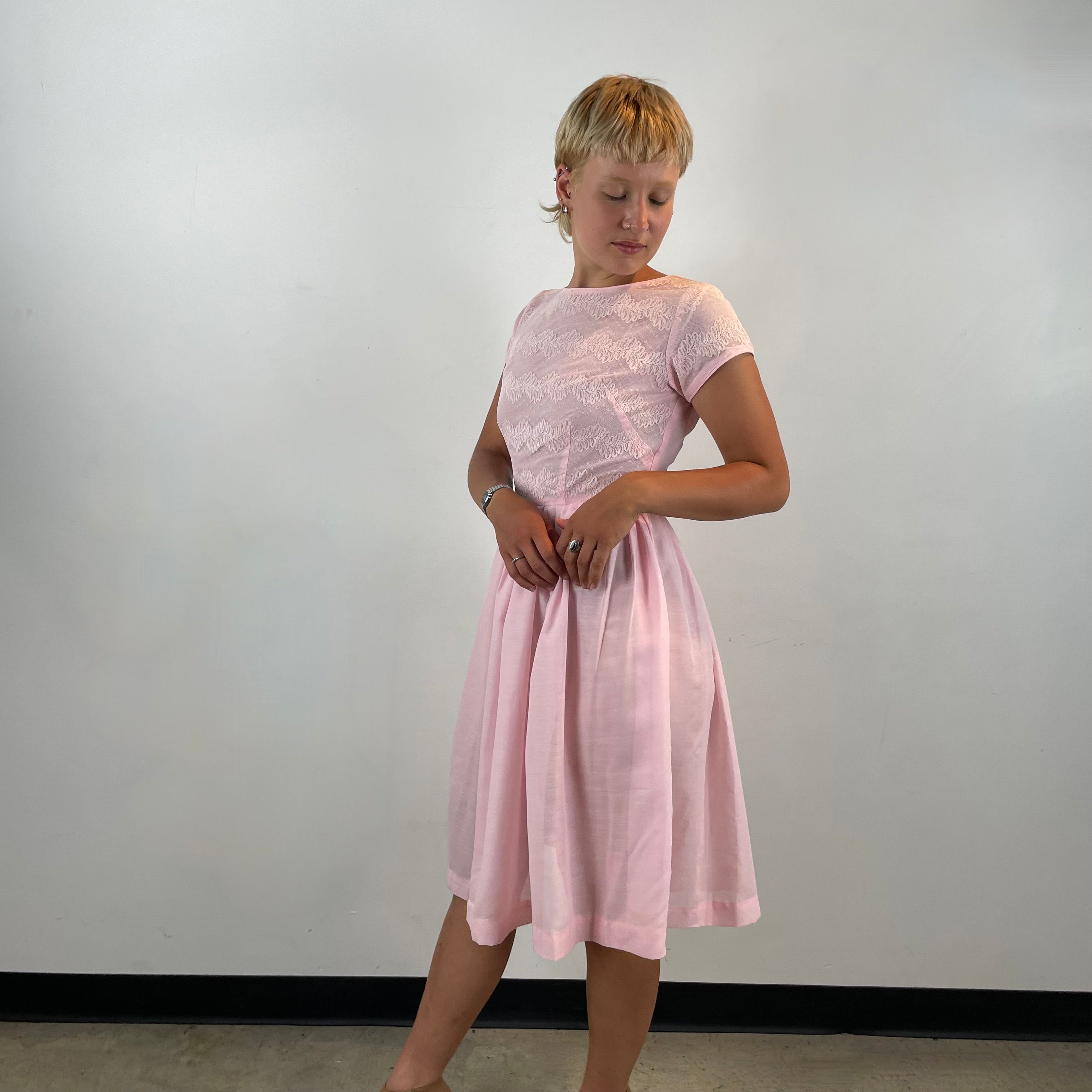 Boheme Vintage 1950s handmade pink lace fit and flare dress with pleated full skirt and short sleeves.