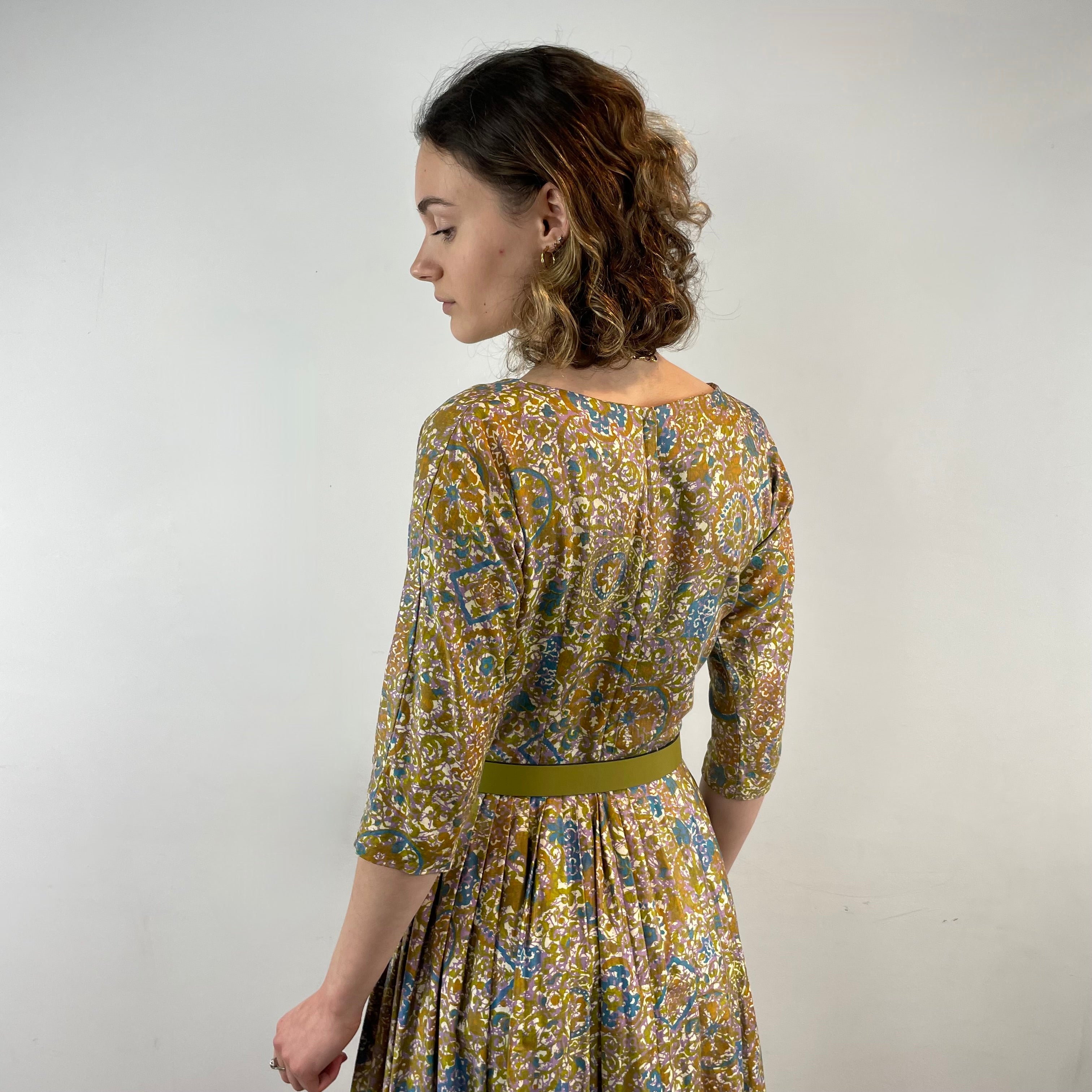 Back View of Boheme Vintage 1950s Meo of California floral cotton dress with pleated midi skirt and dolman sleeves.
