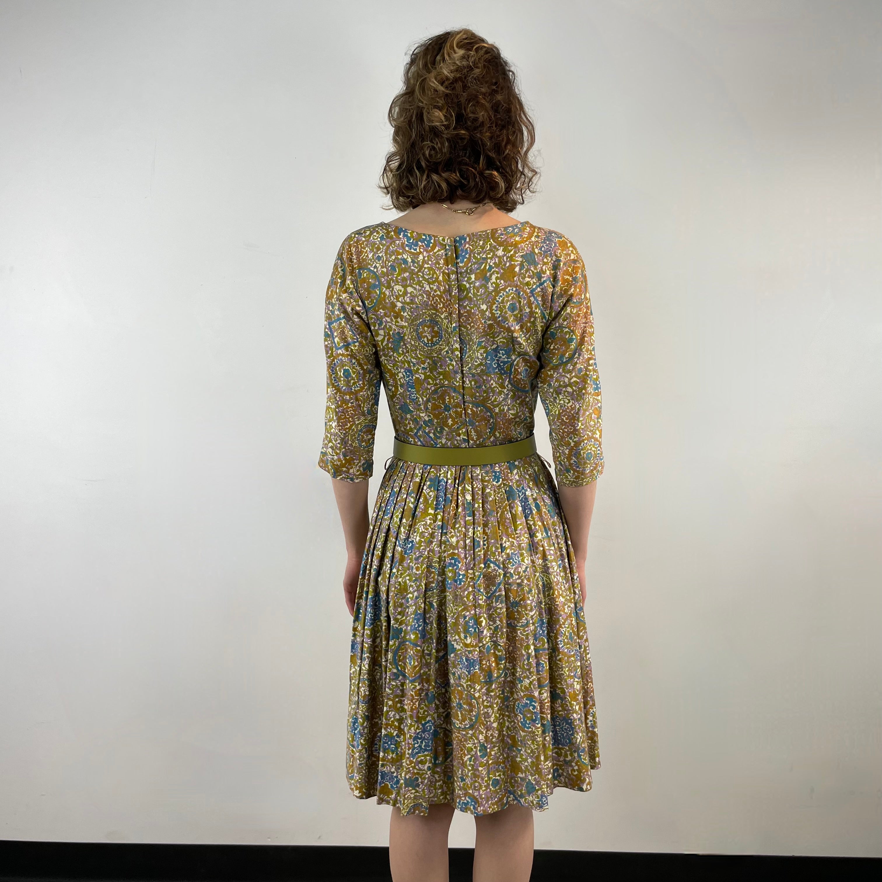 Back View of Boheme Vintage 1950s Meo of California floral cotton dress with pleated midi skirt and dolman sleeves.