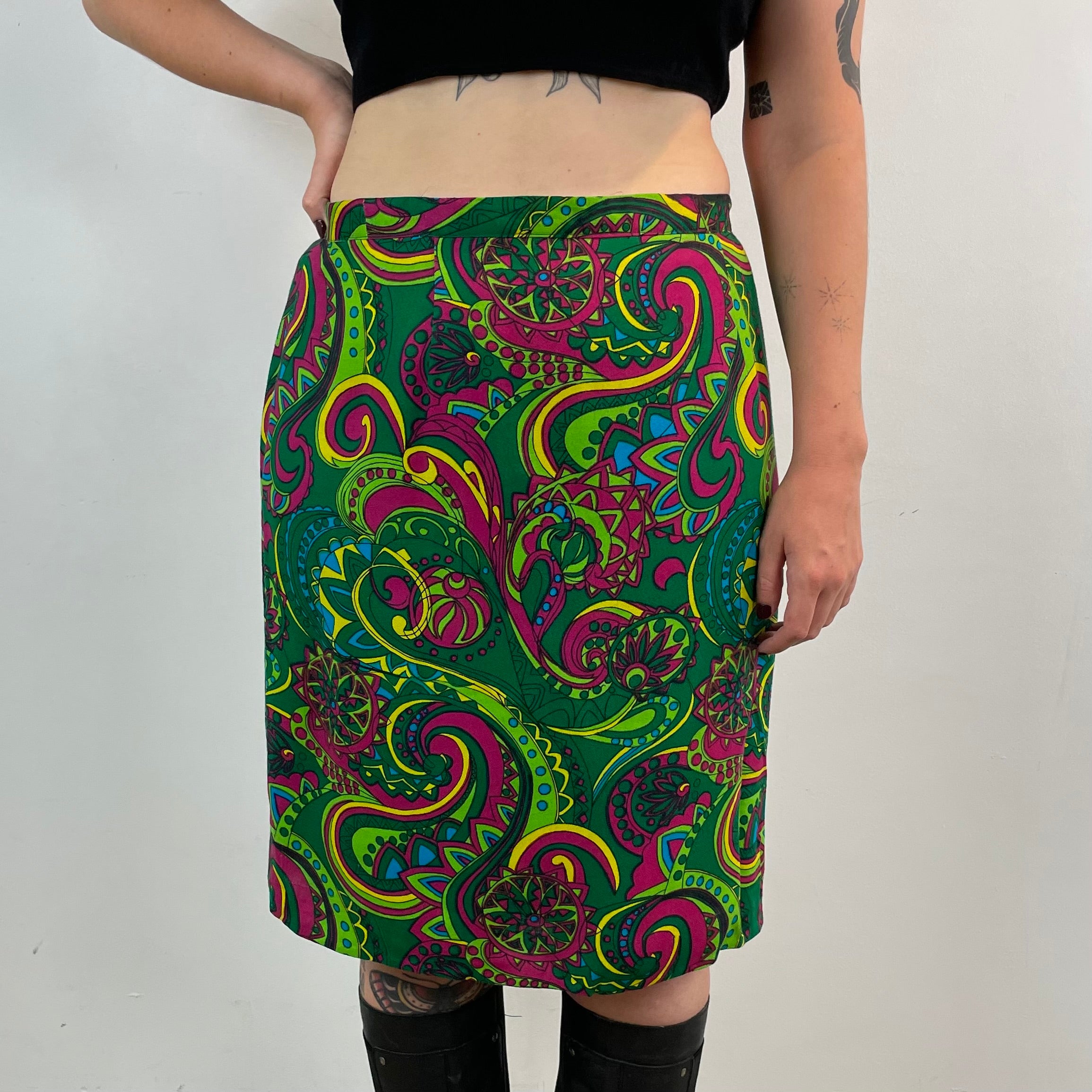 Vintage 1960s handmade skirt with a bold colorful psychedelic paisley print, straight cut, fitted hips, acetate lining and side metal zipper.