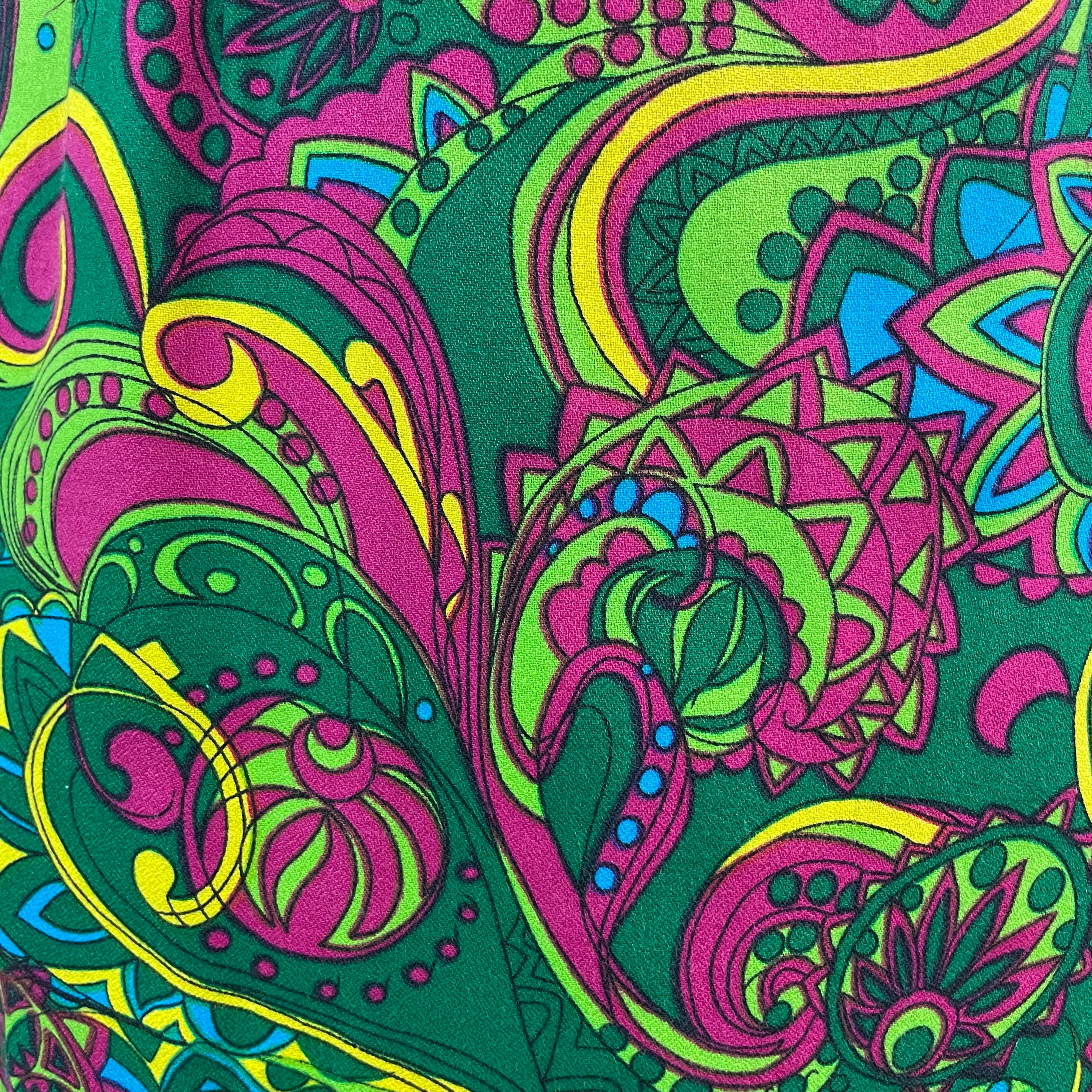 Vintage 1960s handmade skirt with a bold colorful psychedelic paisley print, straight cut, fitted hips, acetate lining and side metal zipper.